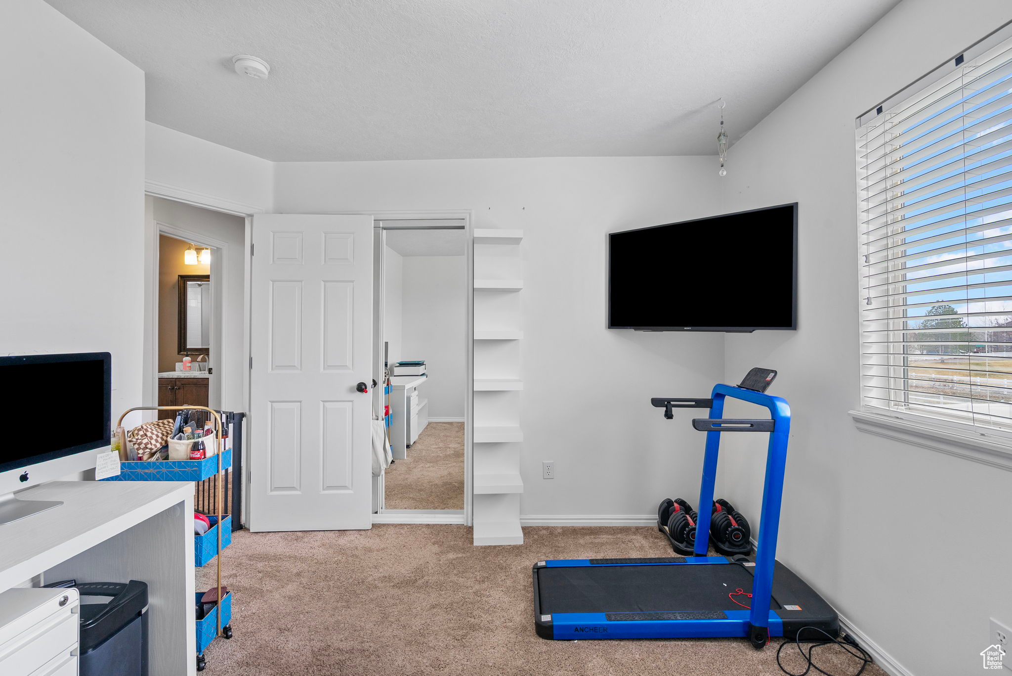 Exercise area with carpet flooring and baseboards