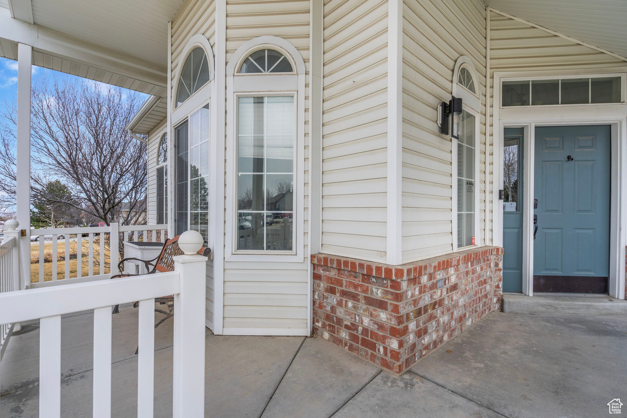 View of exterior entry with brick siding