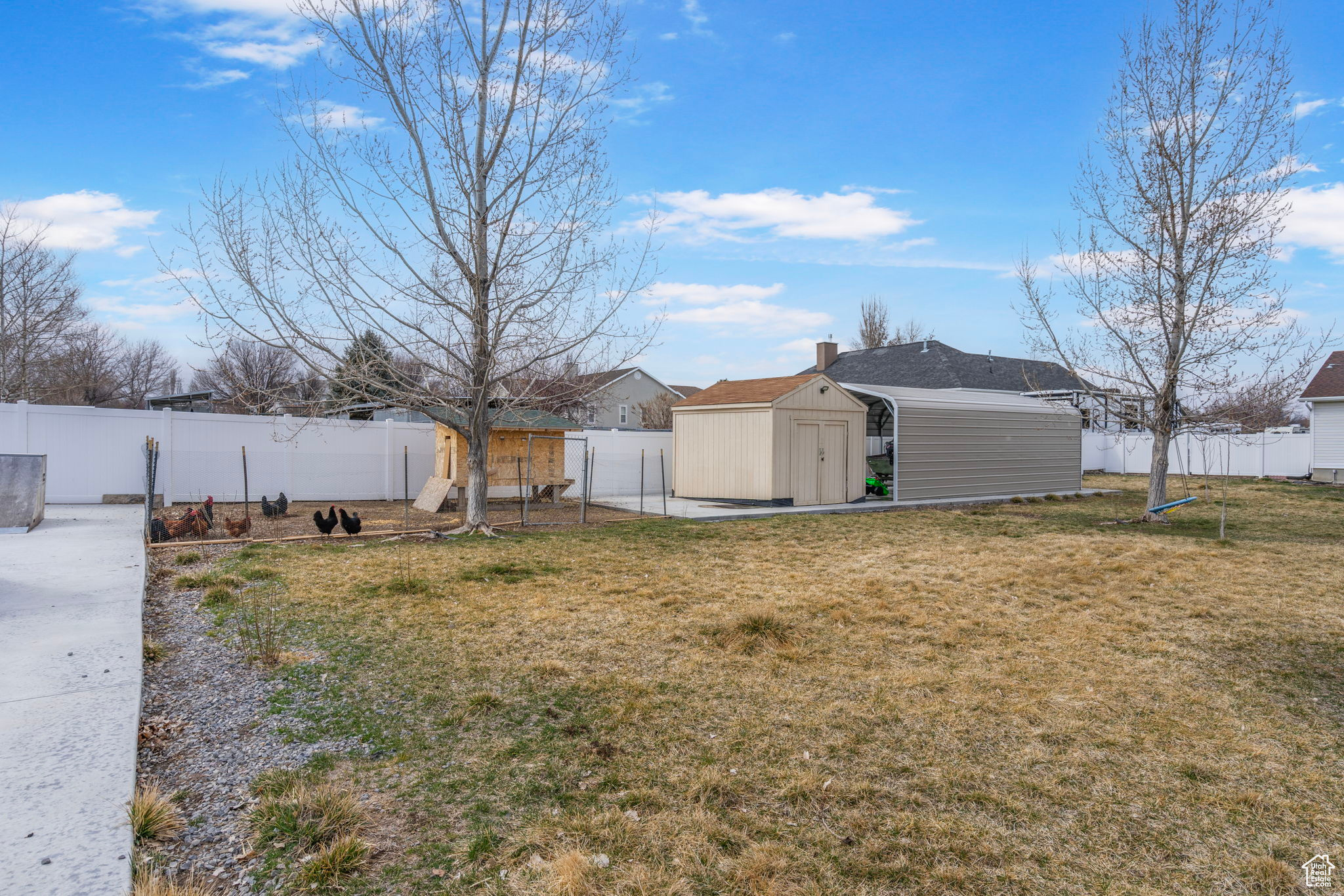 View of yard featuring a storage unit, an outbuilding, and a fenced backyard