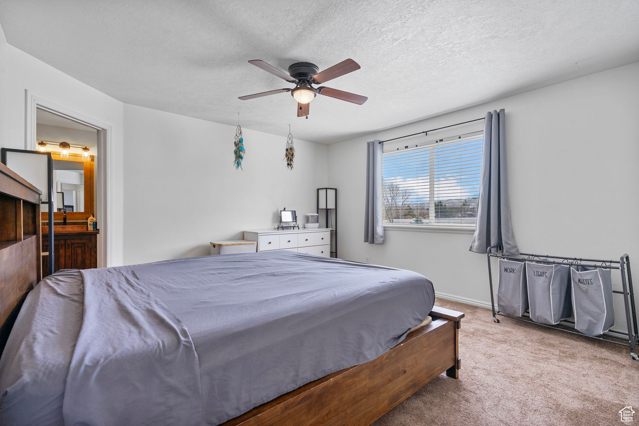 Bedroom featuring baseboards, carpet, ceiling fan, and a textured ceiling