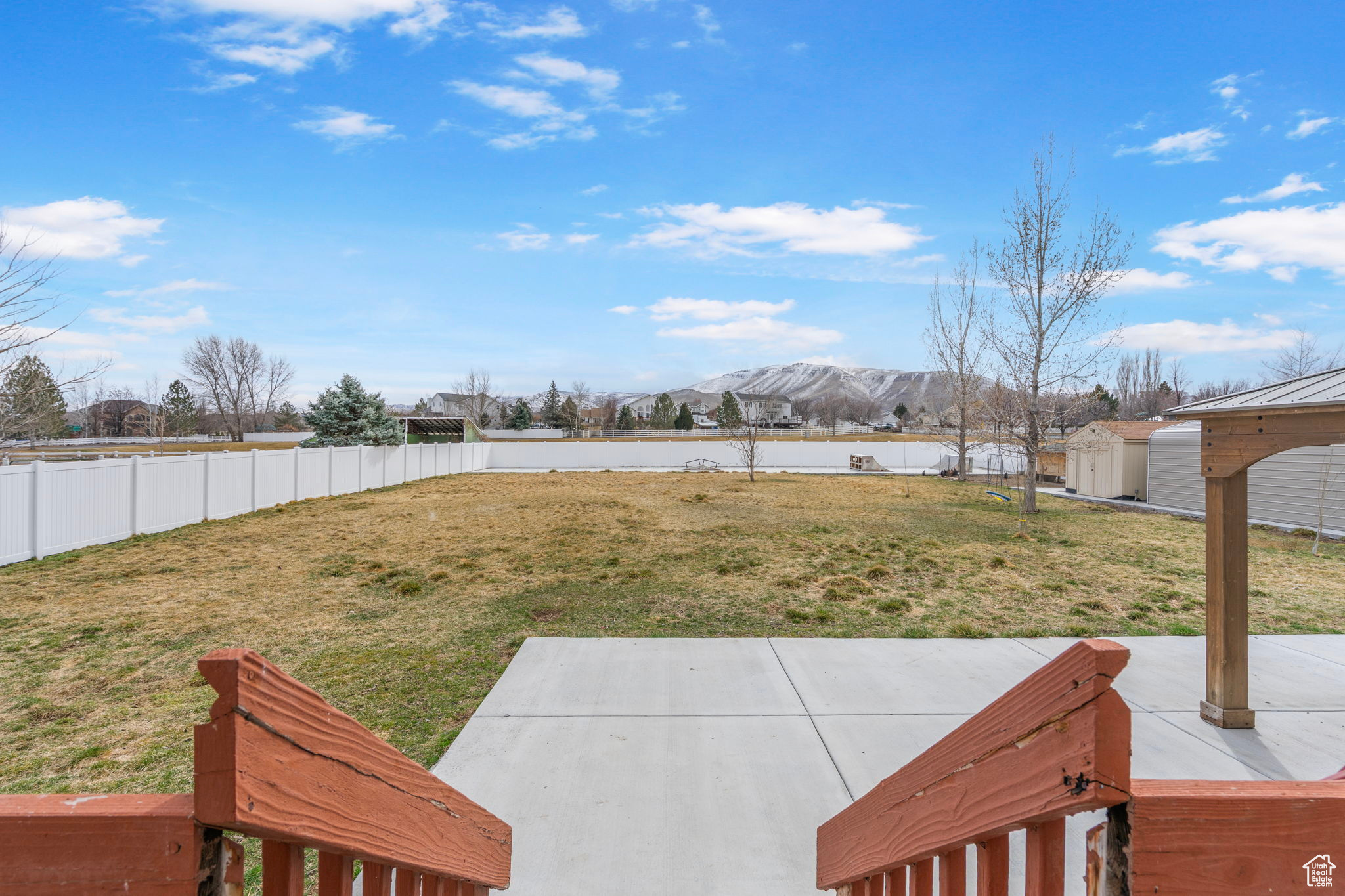 View of yard featuring a patio, an outbuilding, a shed, a fenced backyard, and a water and mountain view