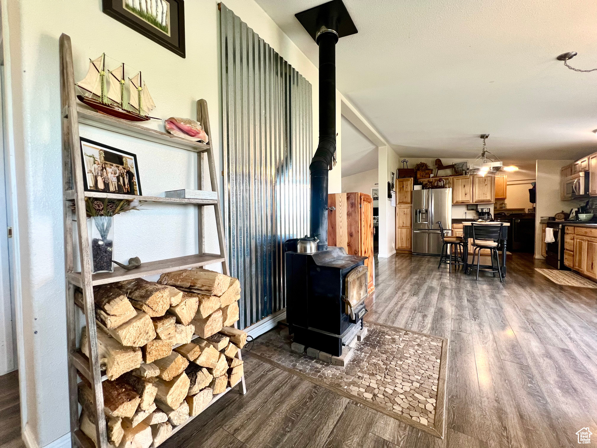 Living area featuring dark wood finished floors and a wood stove