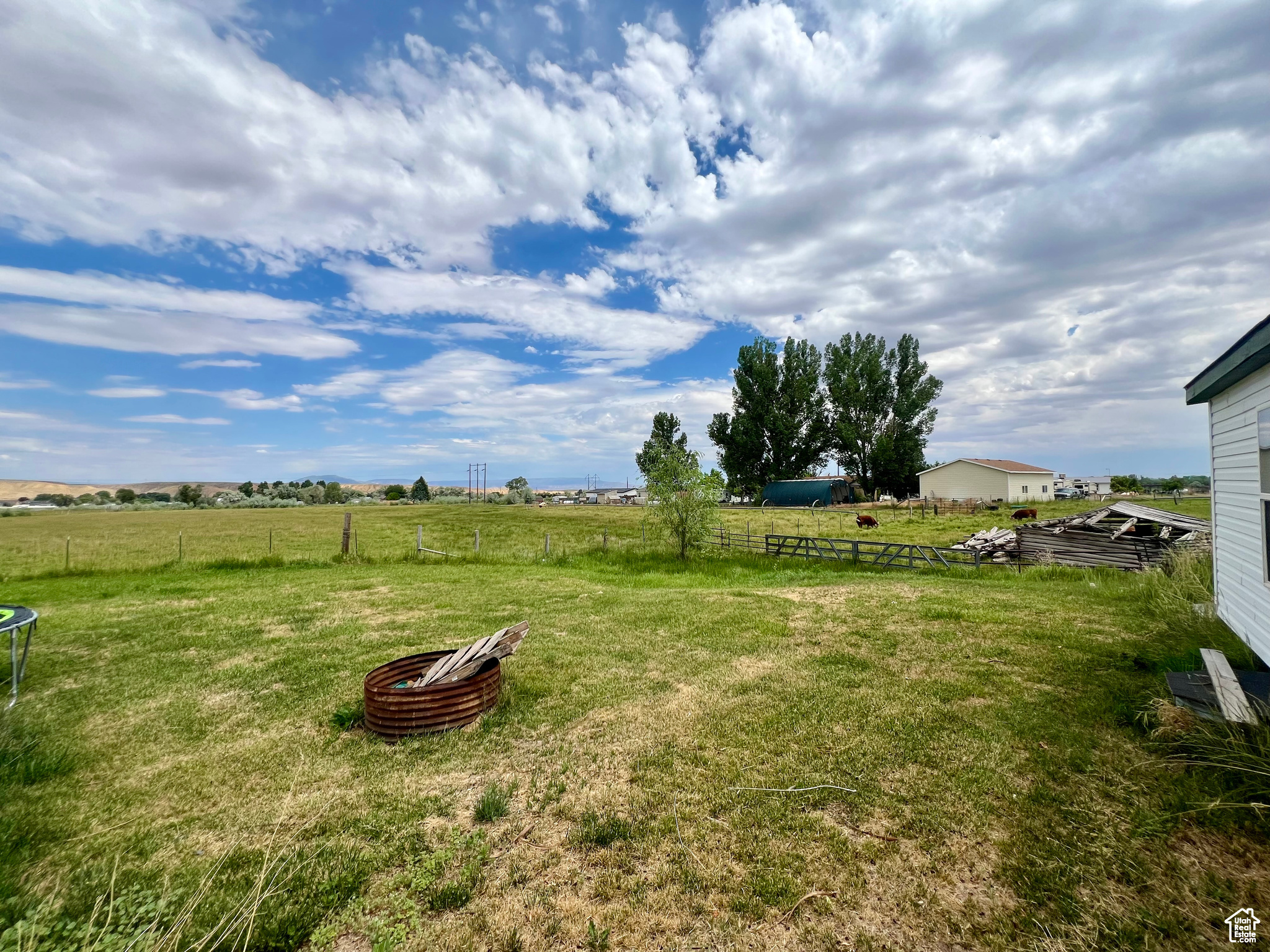 View of yard featuring a rural view and fence