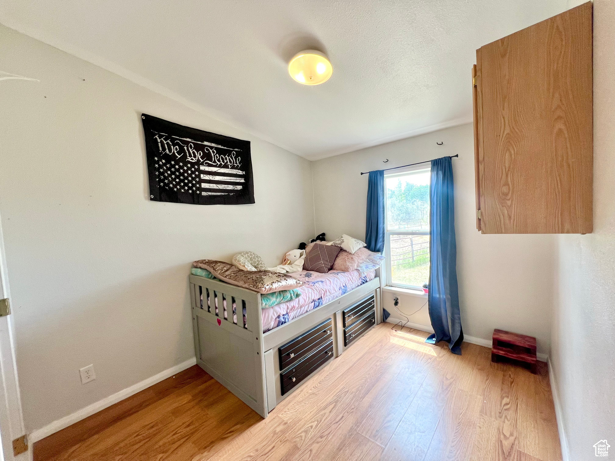 Bedroom with baseboards and wood finished floors