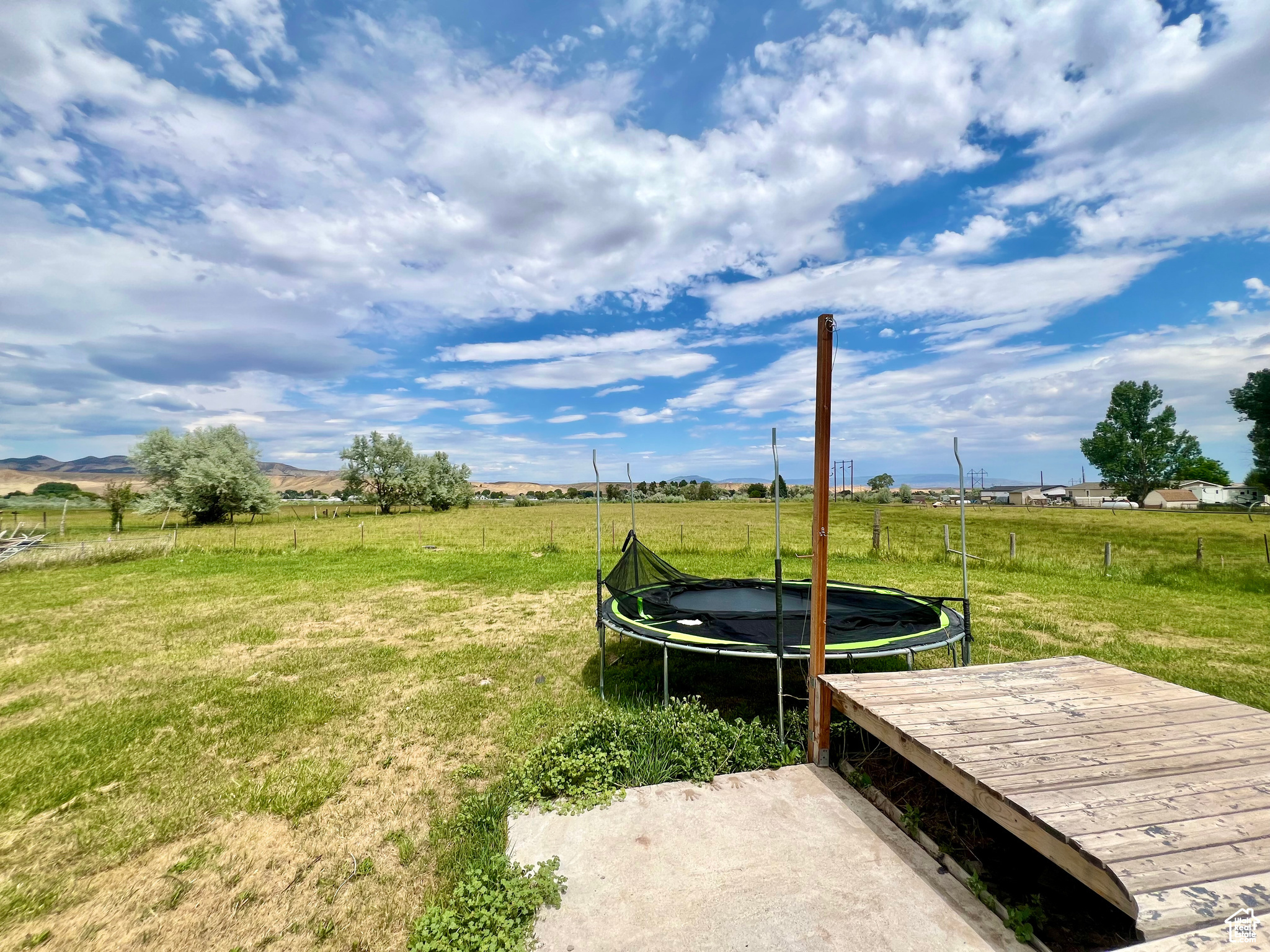 View of yard featuring a trampoline and a rural view