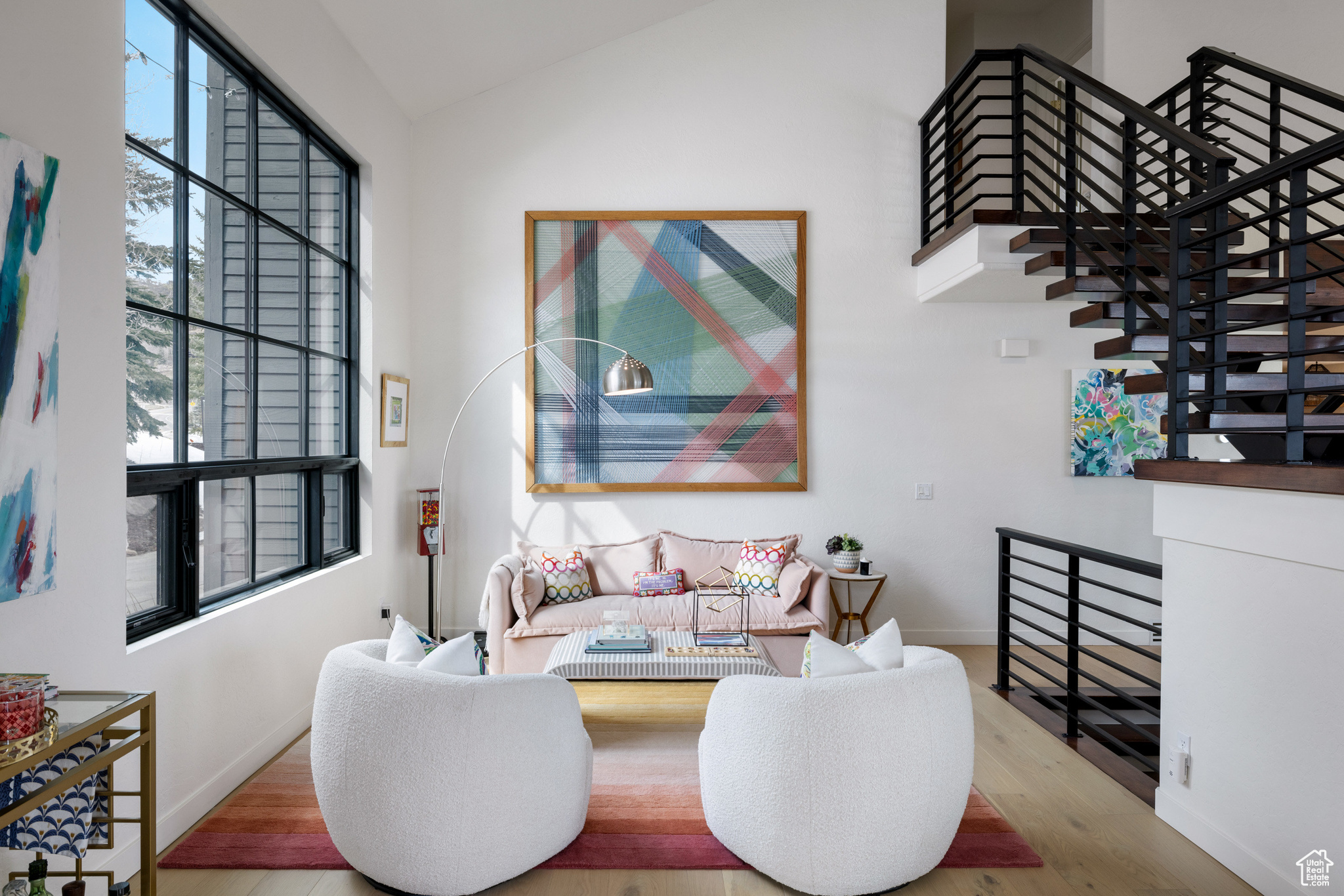 Living room featuring baseboards, wood finished floors, and vaulted ceiling