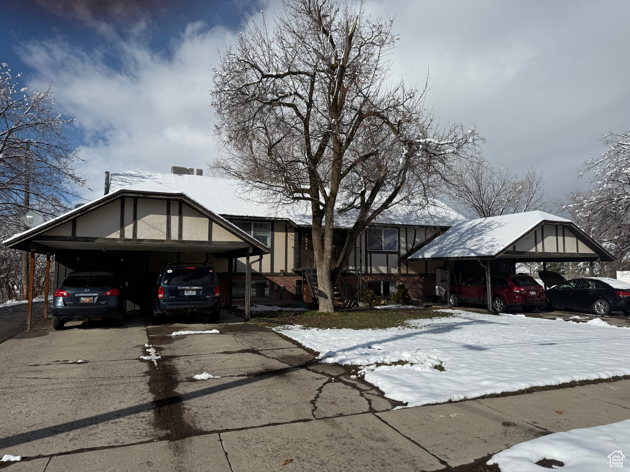 View of front of property featuring a carport and driveway