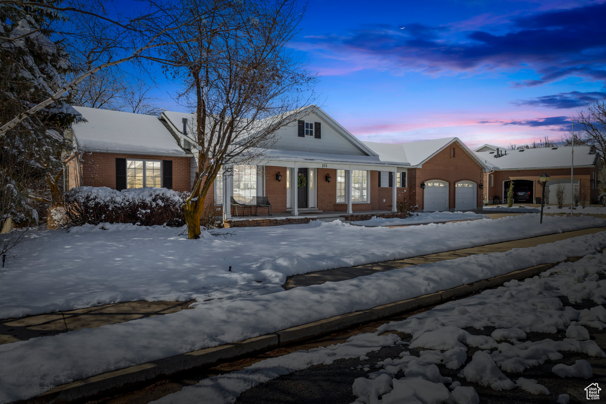 View of front of home featuring brick siding and an attached garage