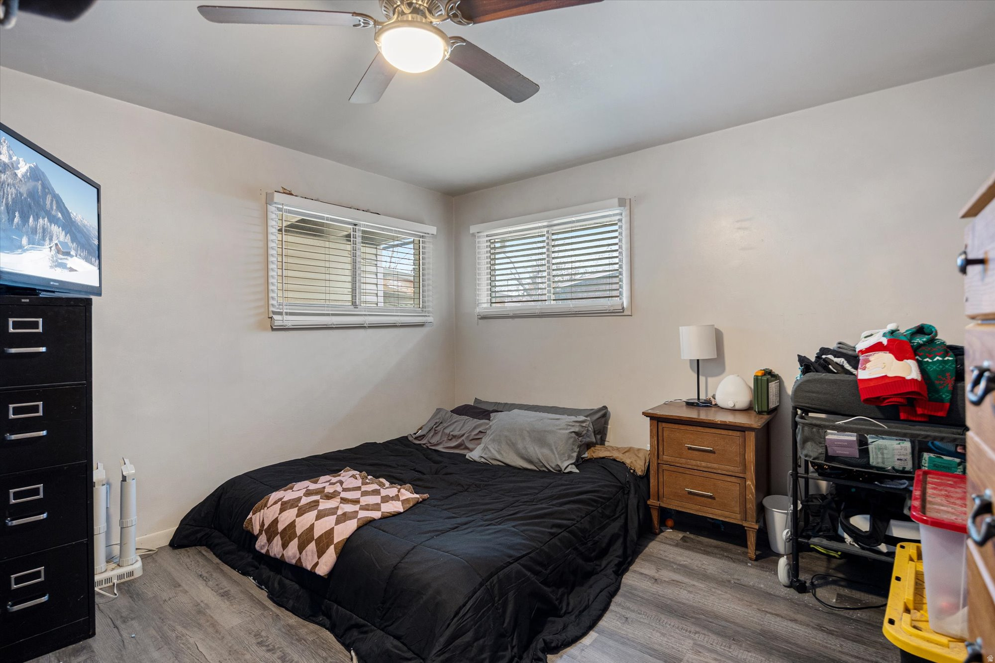 Bedroom with wood finished floors and ceiling fan