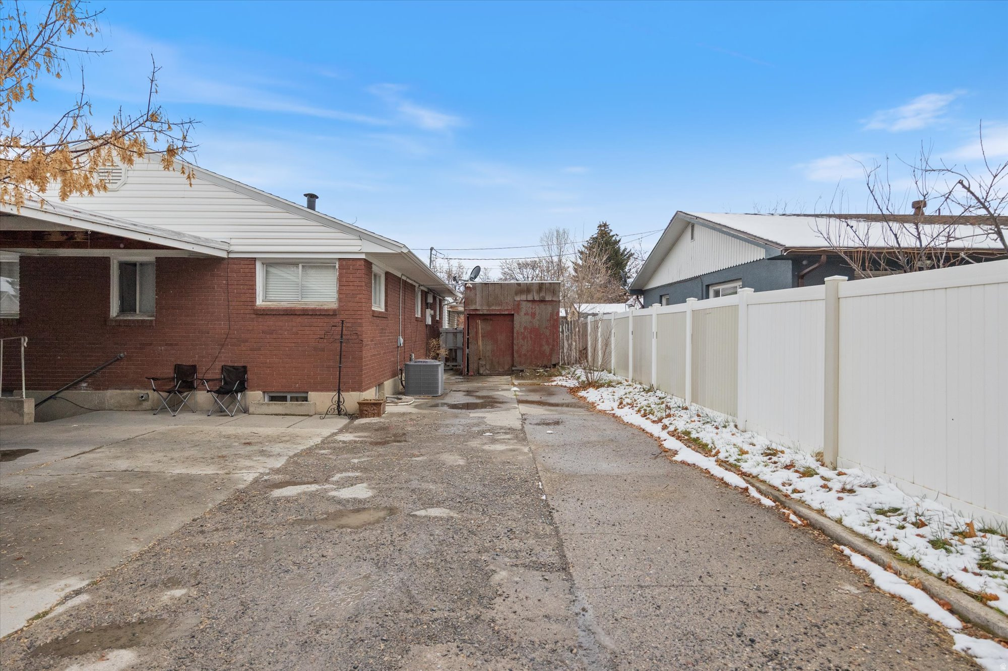 View of property exterior featuring a fenced backyard and brick siding