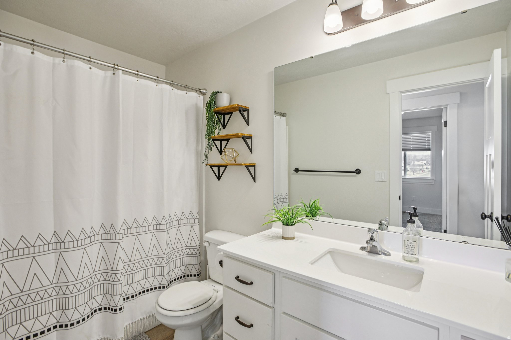 Bathroom with vanity and a shower with shower curtain