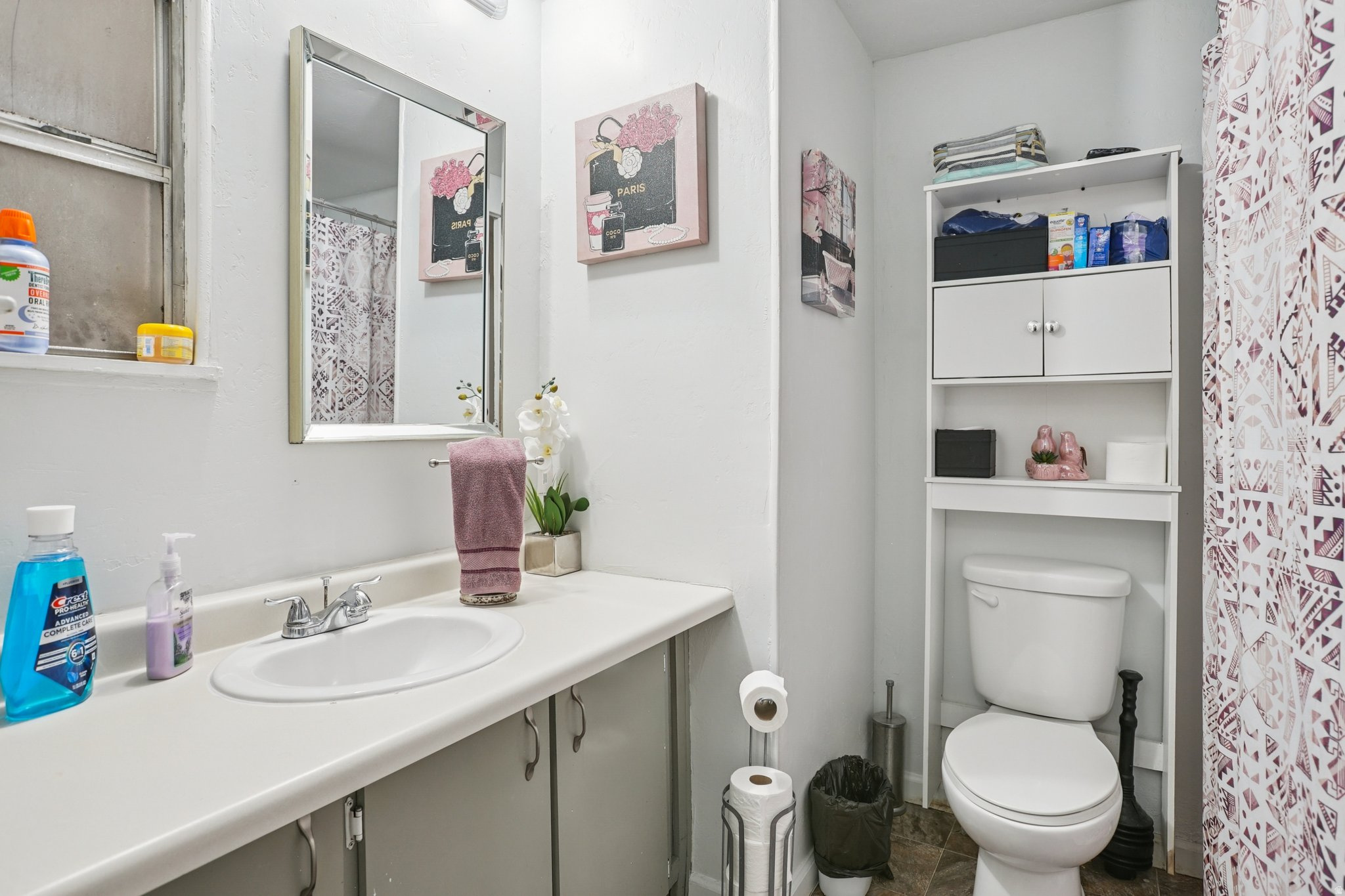Bathroom with curtained shower and vanity