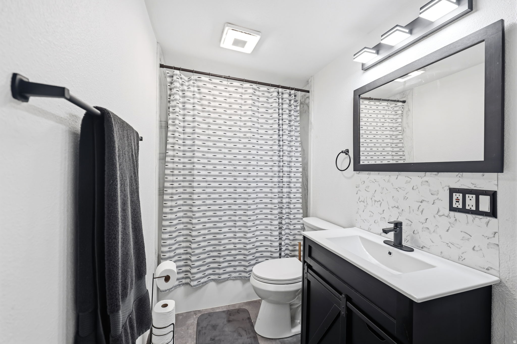 Full bath featuring vanity and shower / bath combo with shower curtain