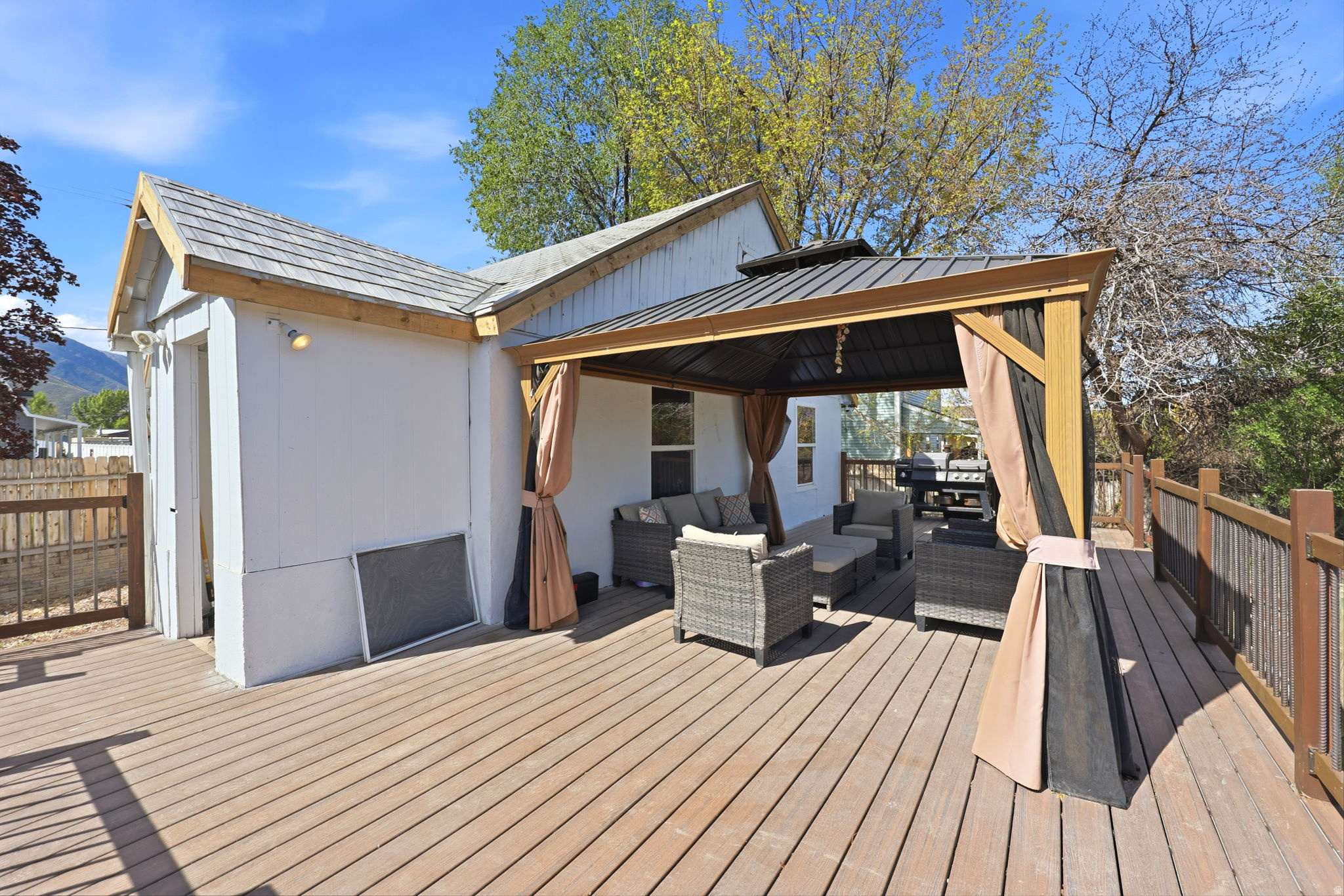 Wooden deck featuring an outdoor living space and a gazebo
