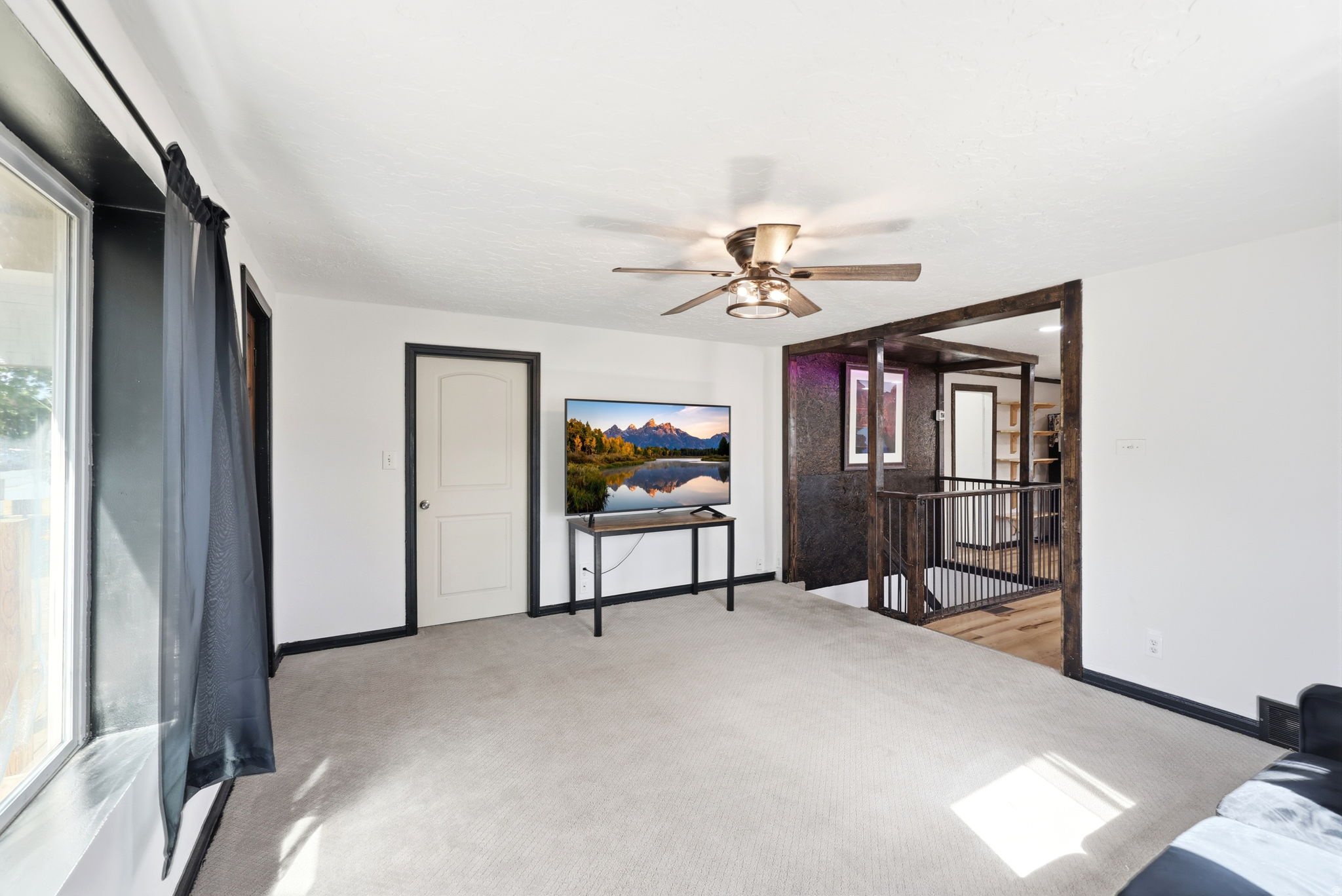 Bedroom with light colored carpet and ceiling fan