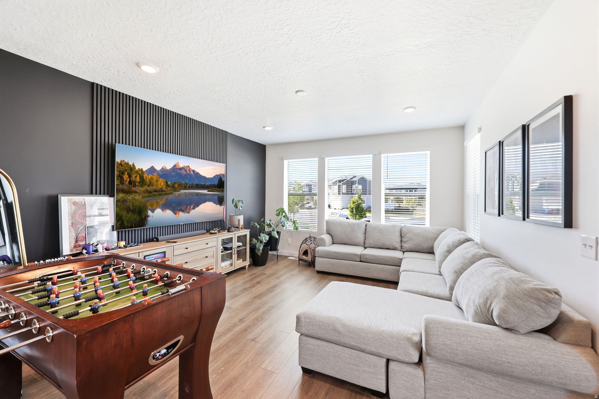 Open-concept living space featuring wood-finish flooring and recessed lighting