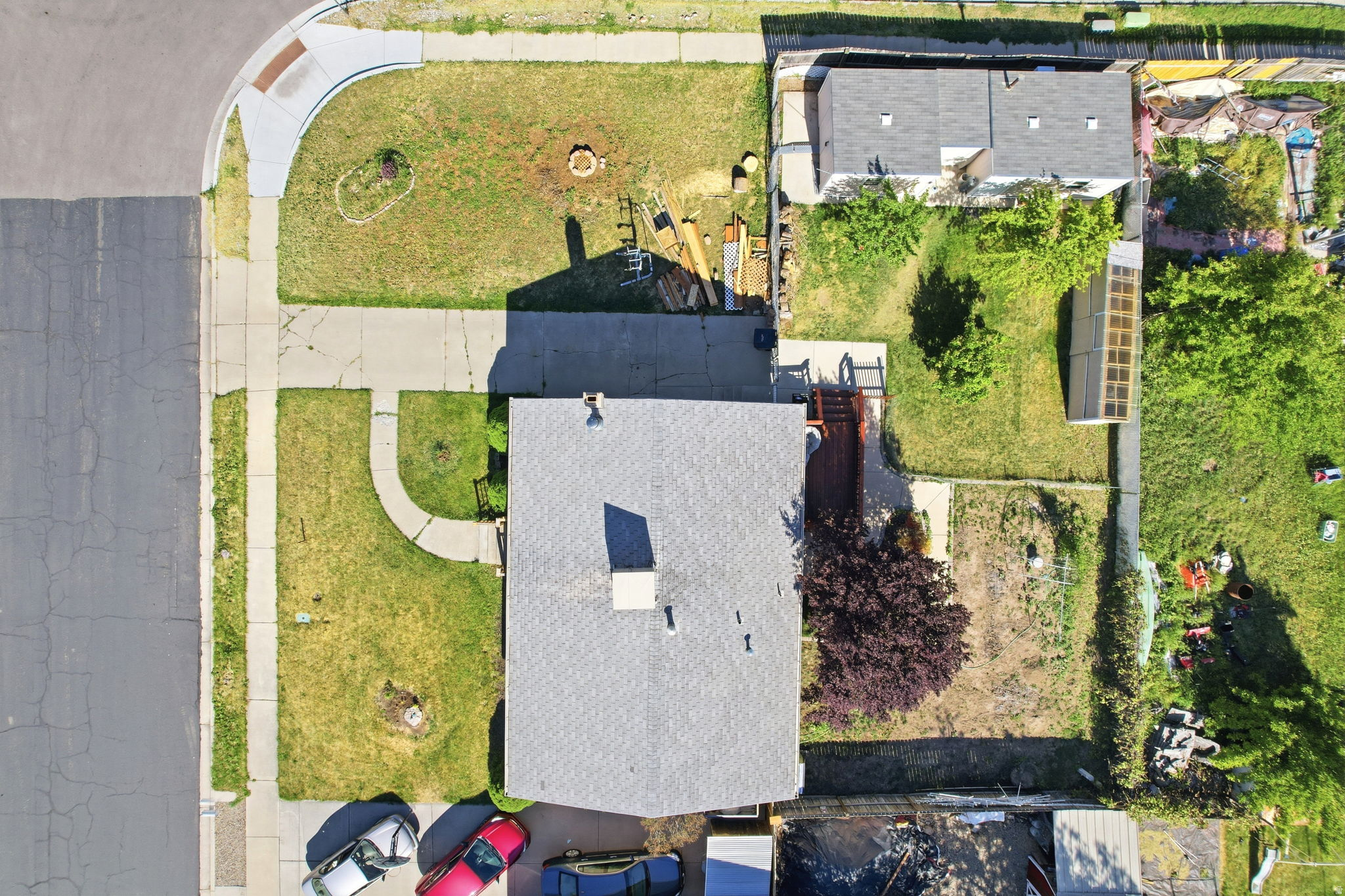 Aerial property view featuring a corner lot with paved street access