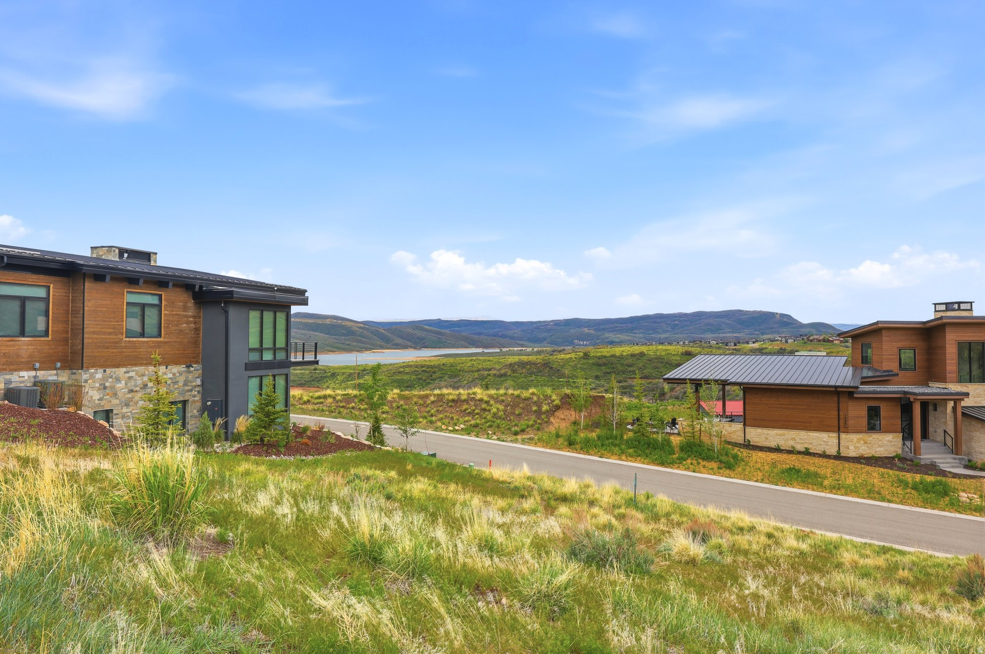 Modern architectural residence featuring a wood-panel and stone facade