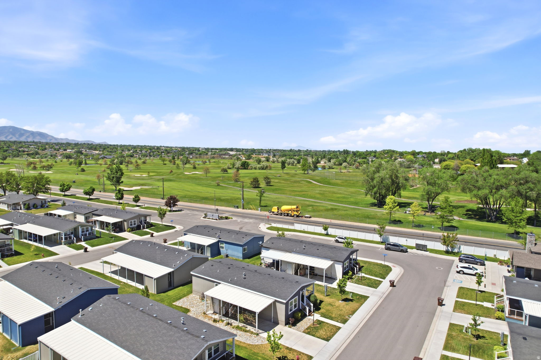 Aerial perspective showcasing a residential community with paved streets and individual home sites