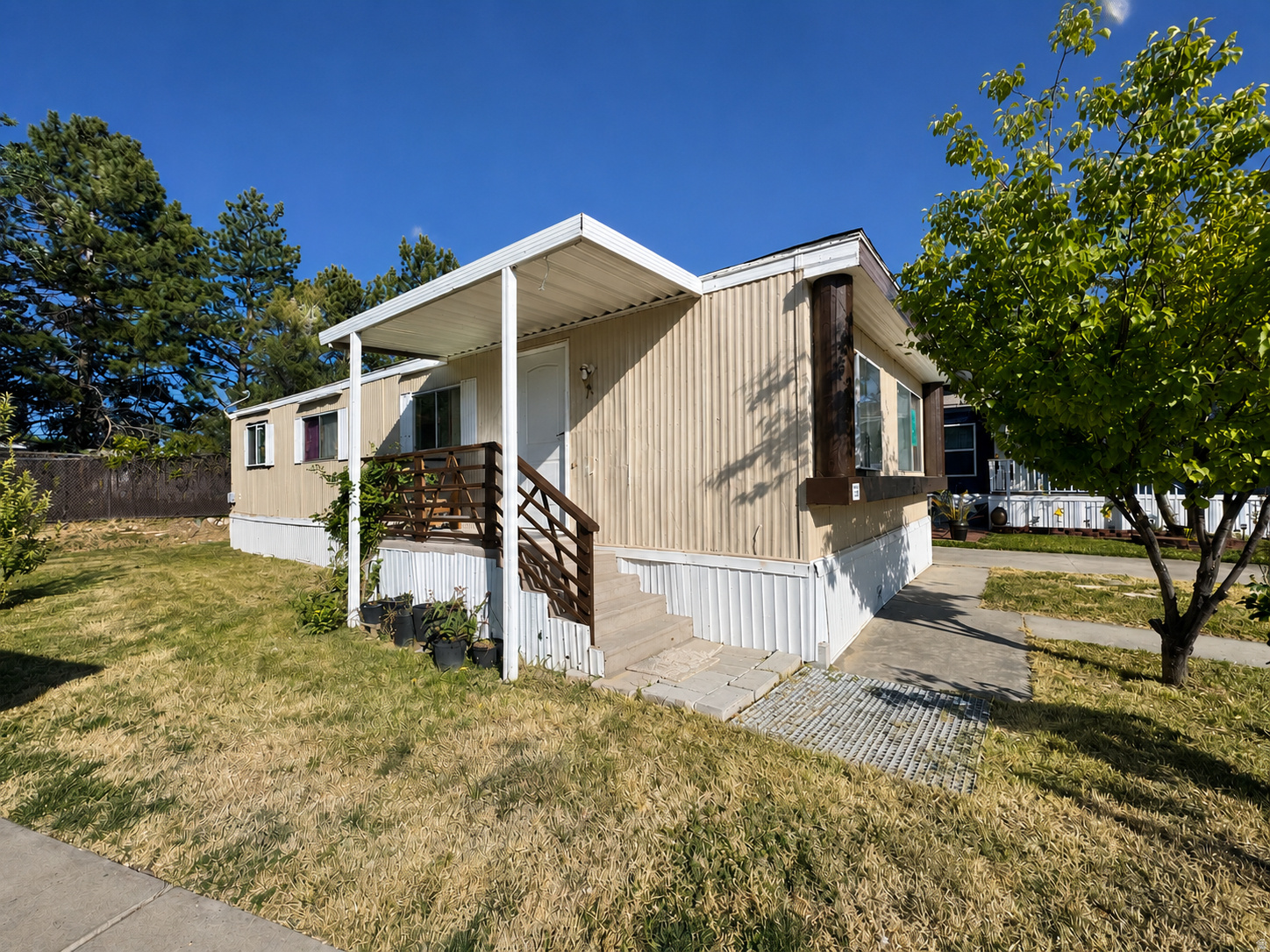 Single-story residence featuring light-colored siding and an attached covered porch