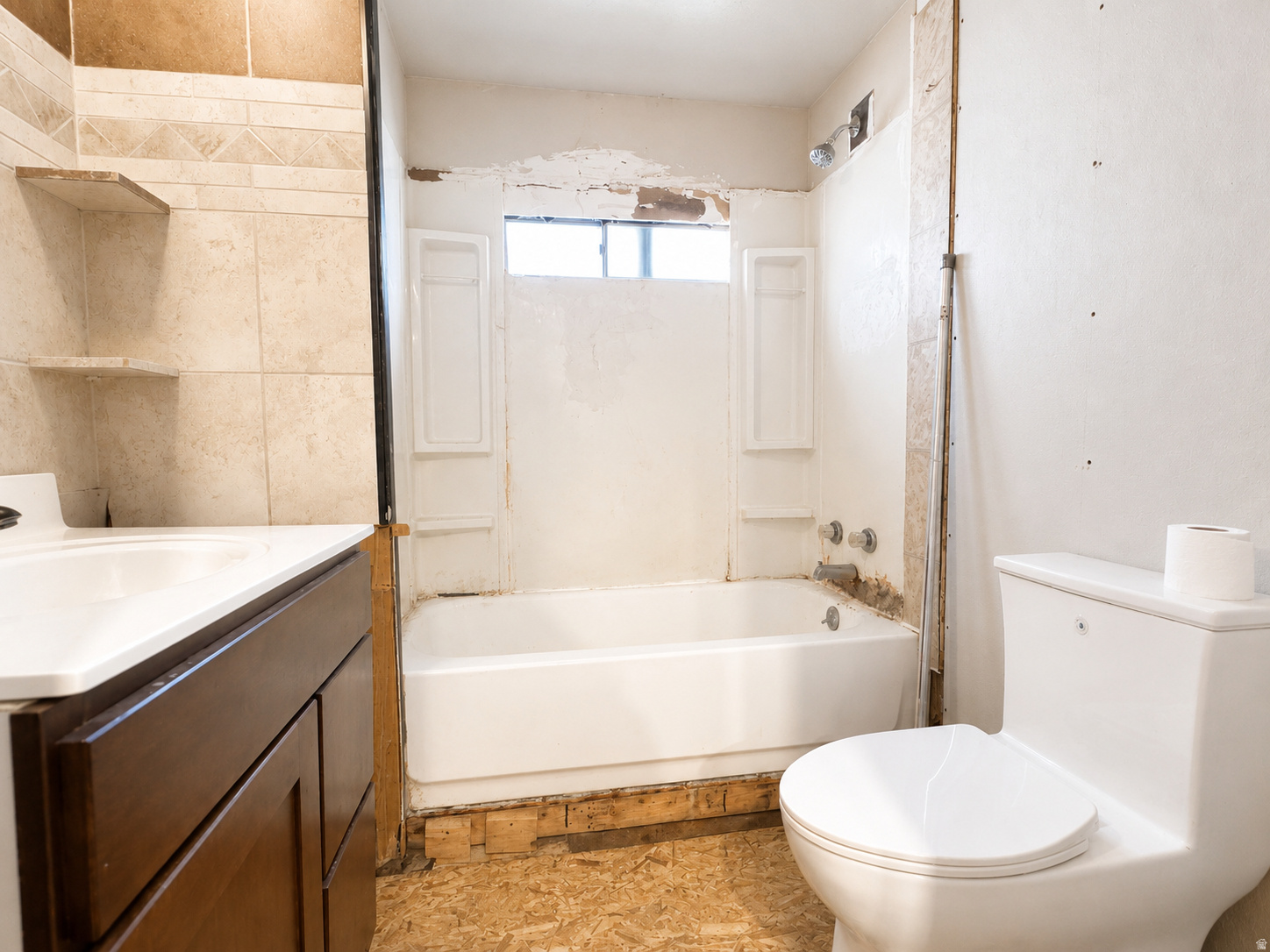 Bathroom featuring a white bathtub, white toilet, and a vanity with a white countertop and wood-finish cabinetry