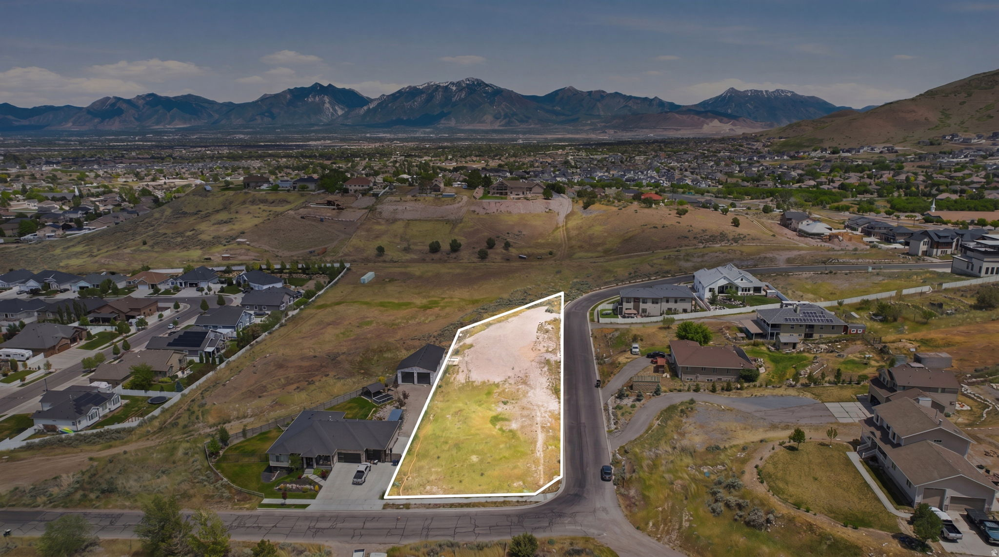 Expansive residential lot with established road frontage, surrounded by existing homes