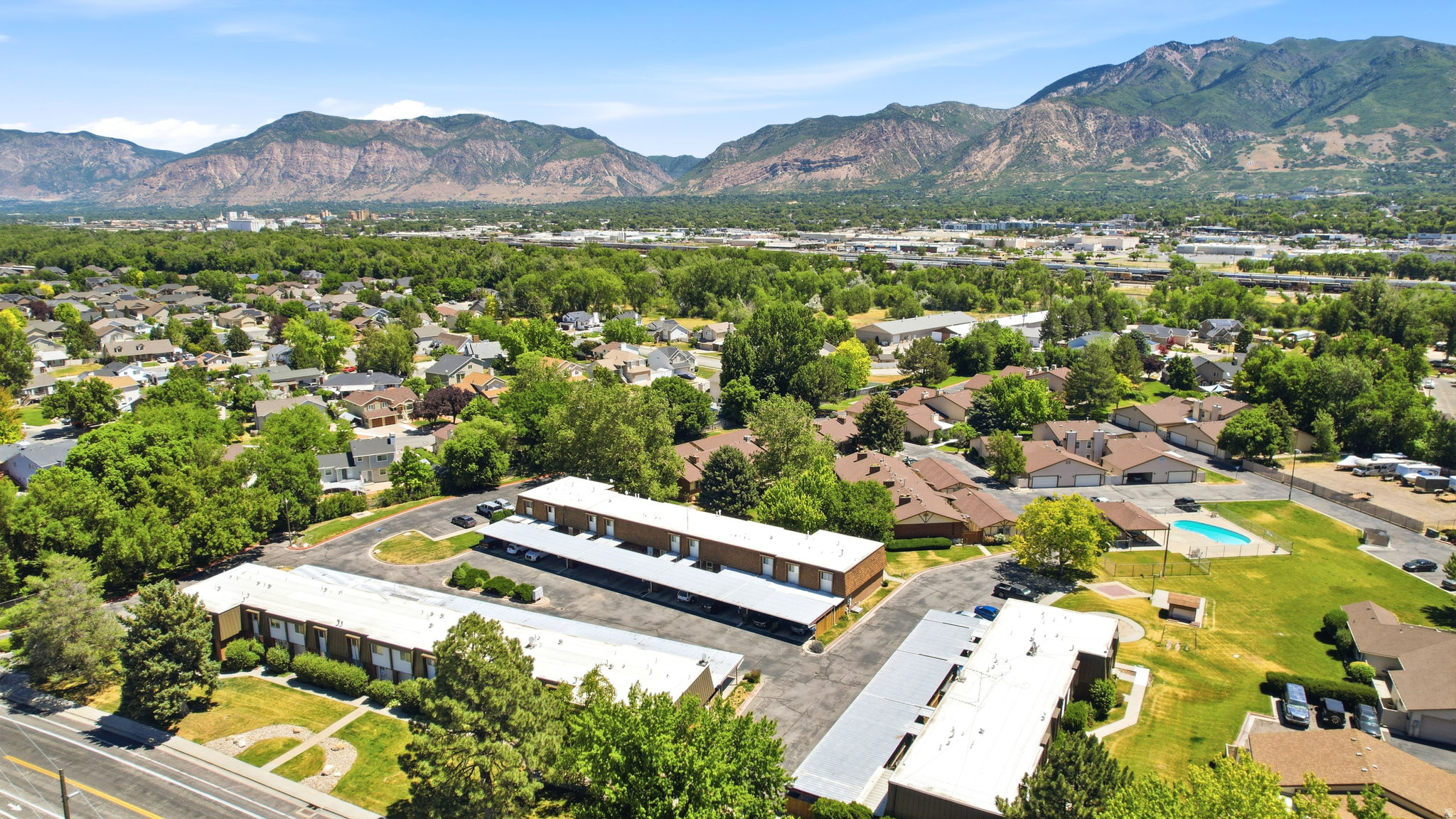 Aerial perspective highlighting multiple residential buildings with mountain scenery