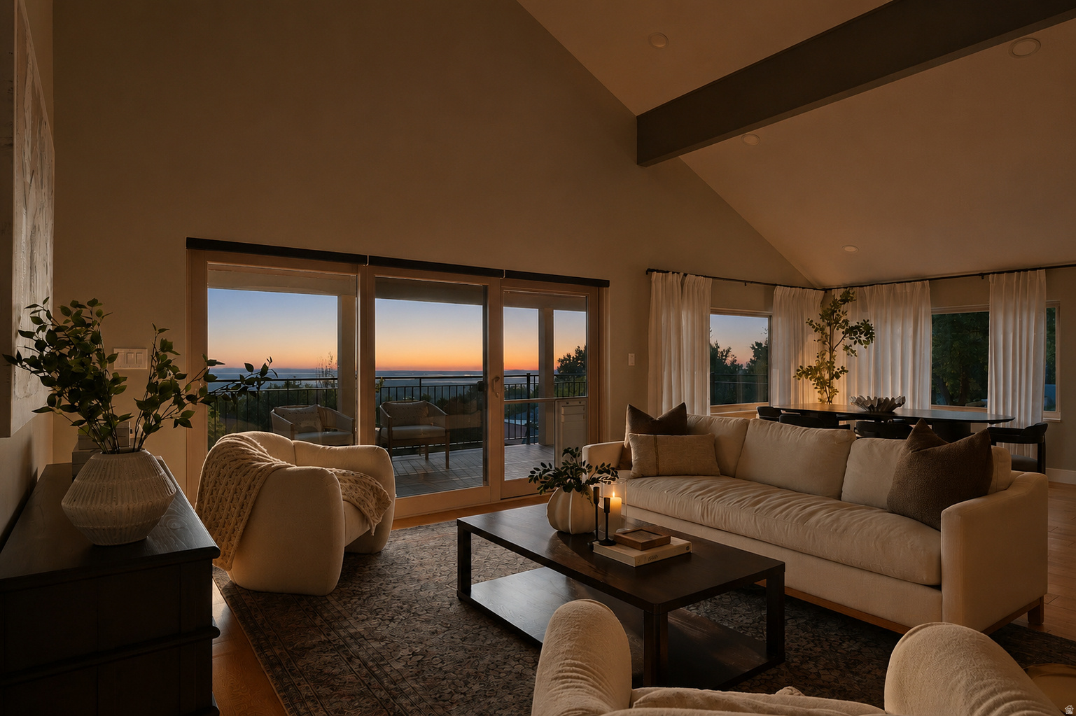 Vaulted ceiling living area with a large slider door opening to a private deck and a broad expanse of sky