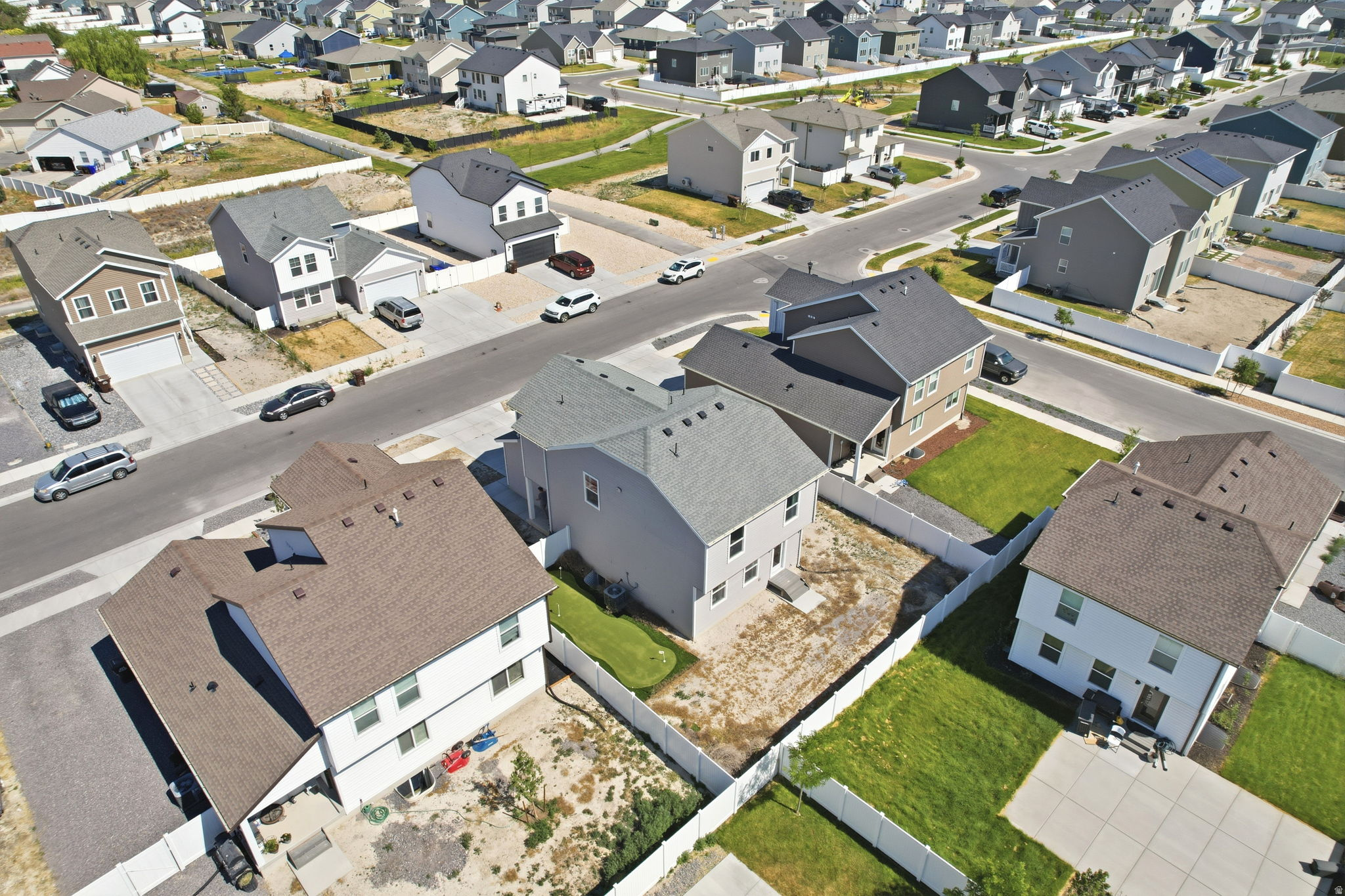 Aerial perspective showcasing a residential community with asphalt streets and individual properties