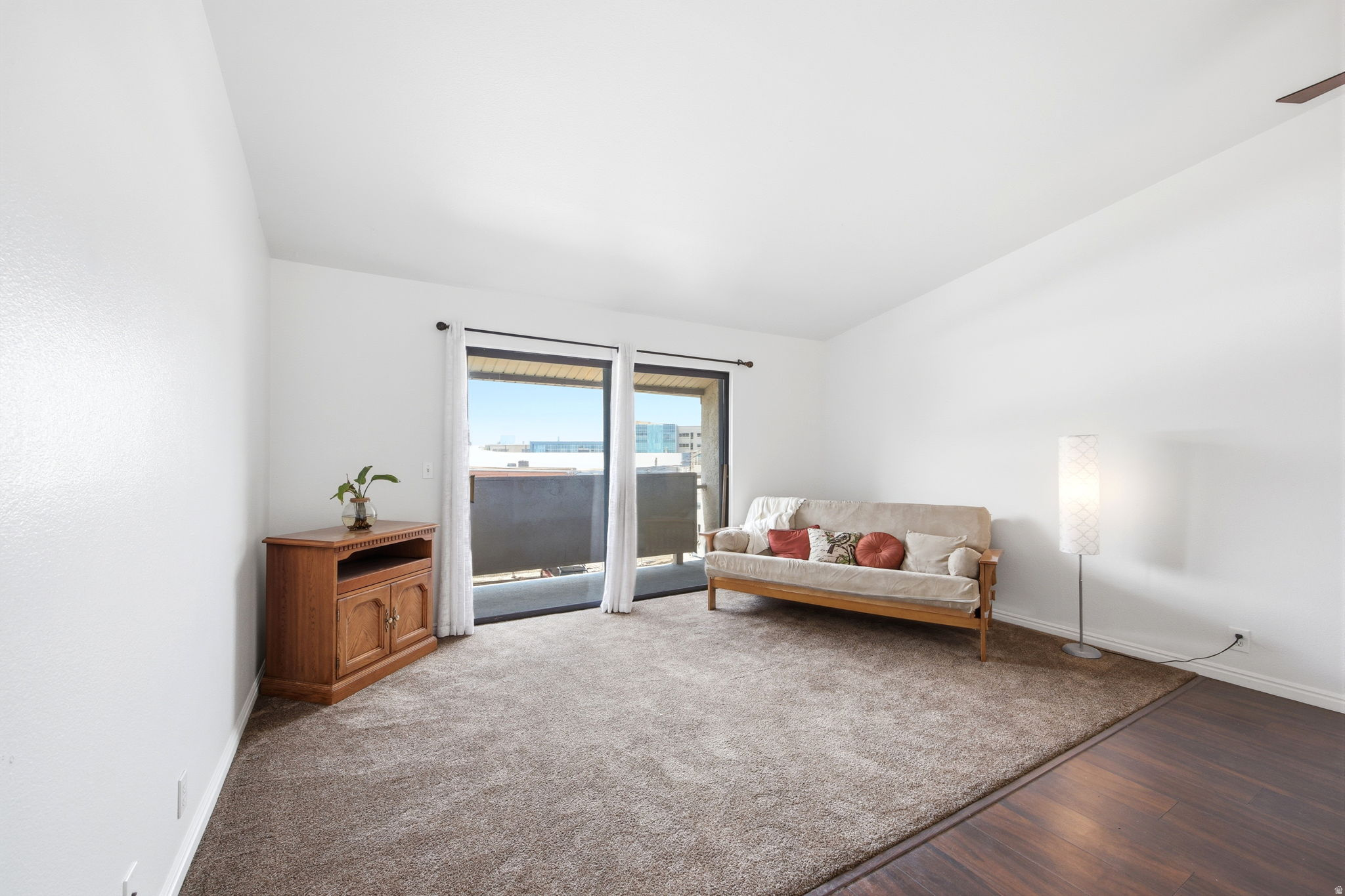Bright living area featuring a sliding glass door to an exterior balcony