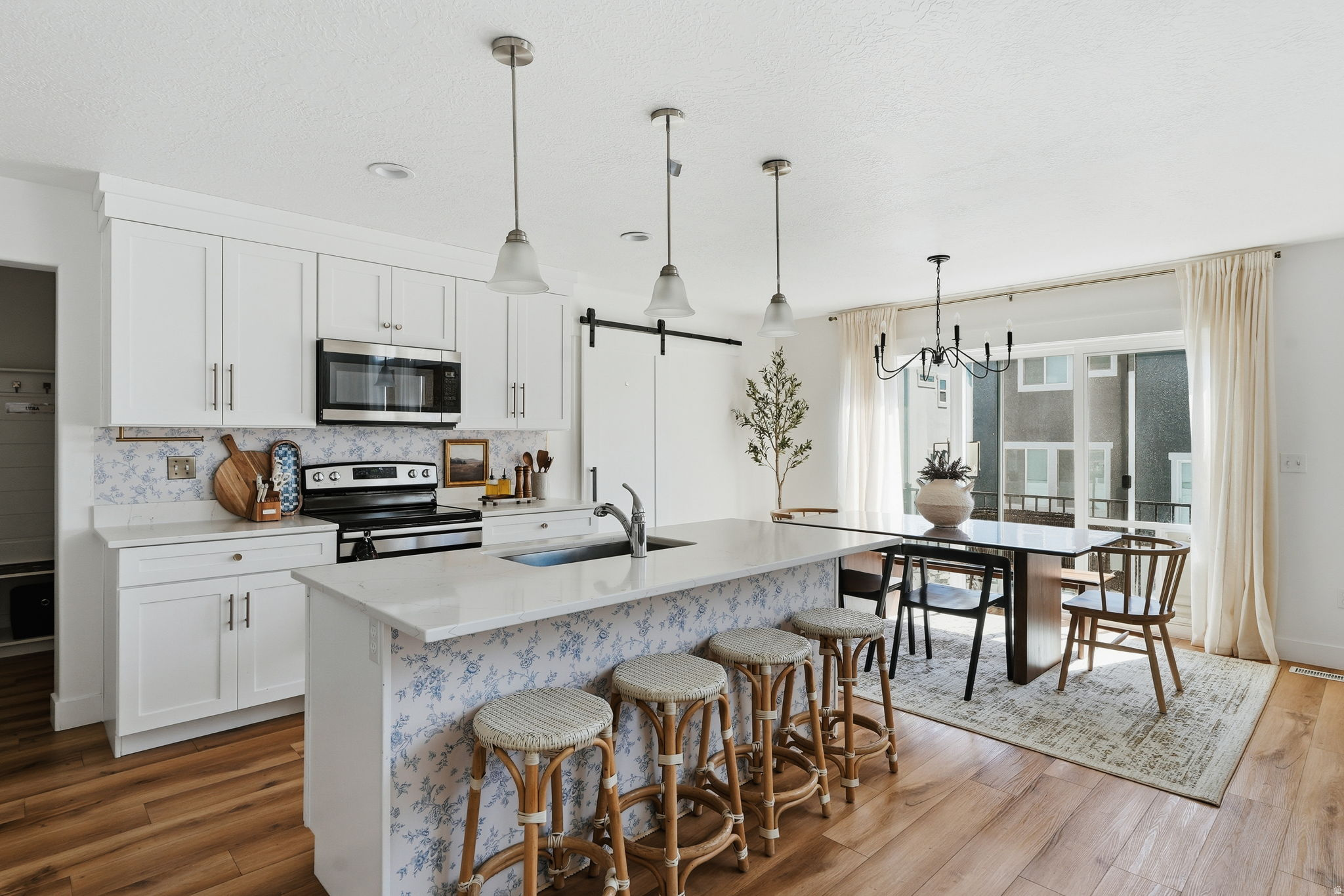 Open-concept kitchen and dining area featuring wood-finish flooring