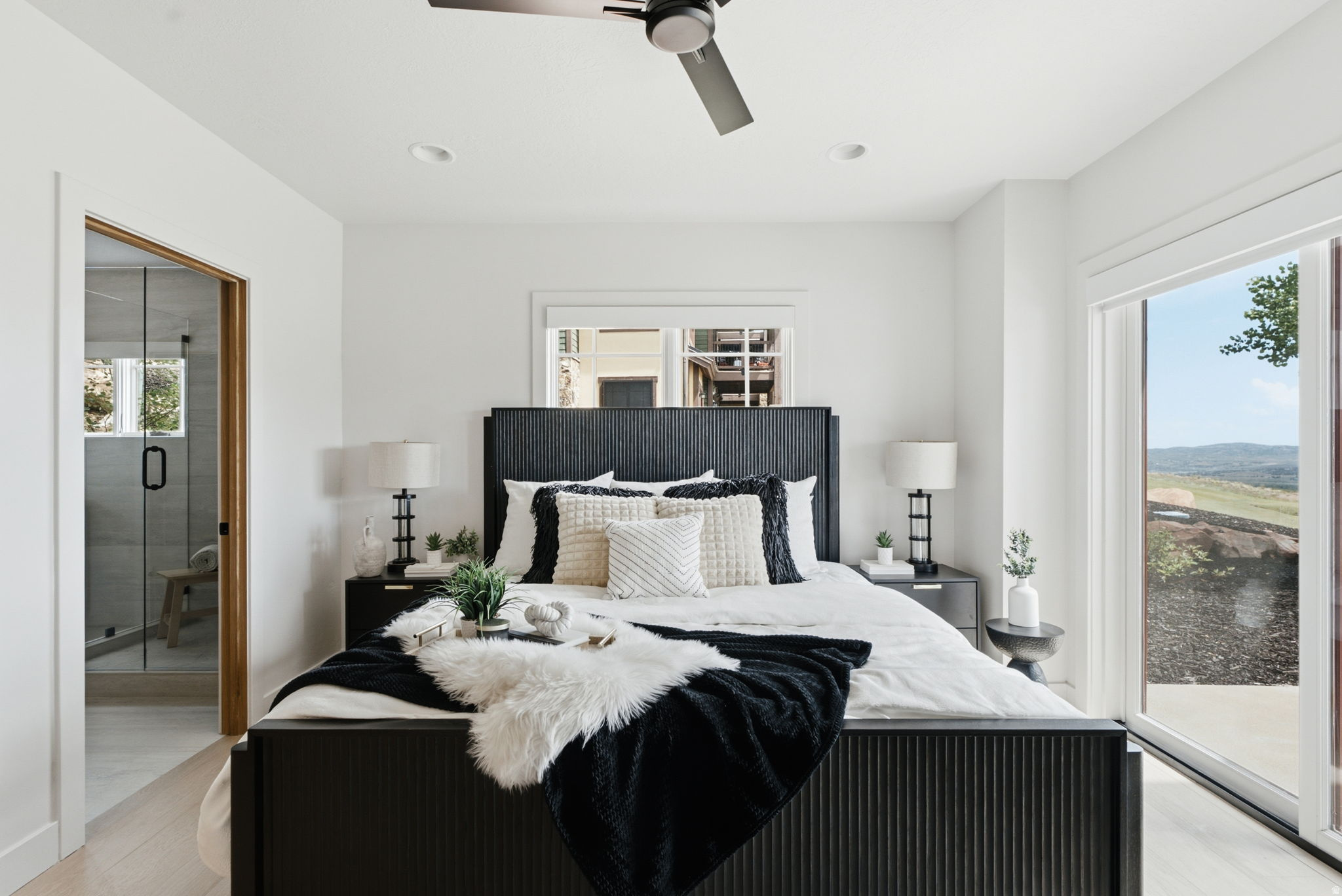 Bedroom featuring new wood-finish flooring and a contemporary ceiling fan