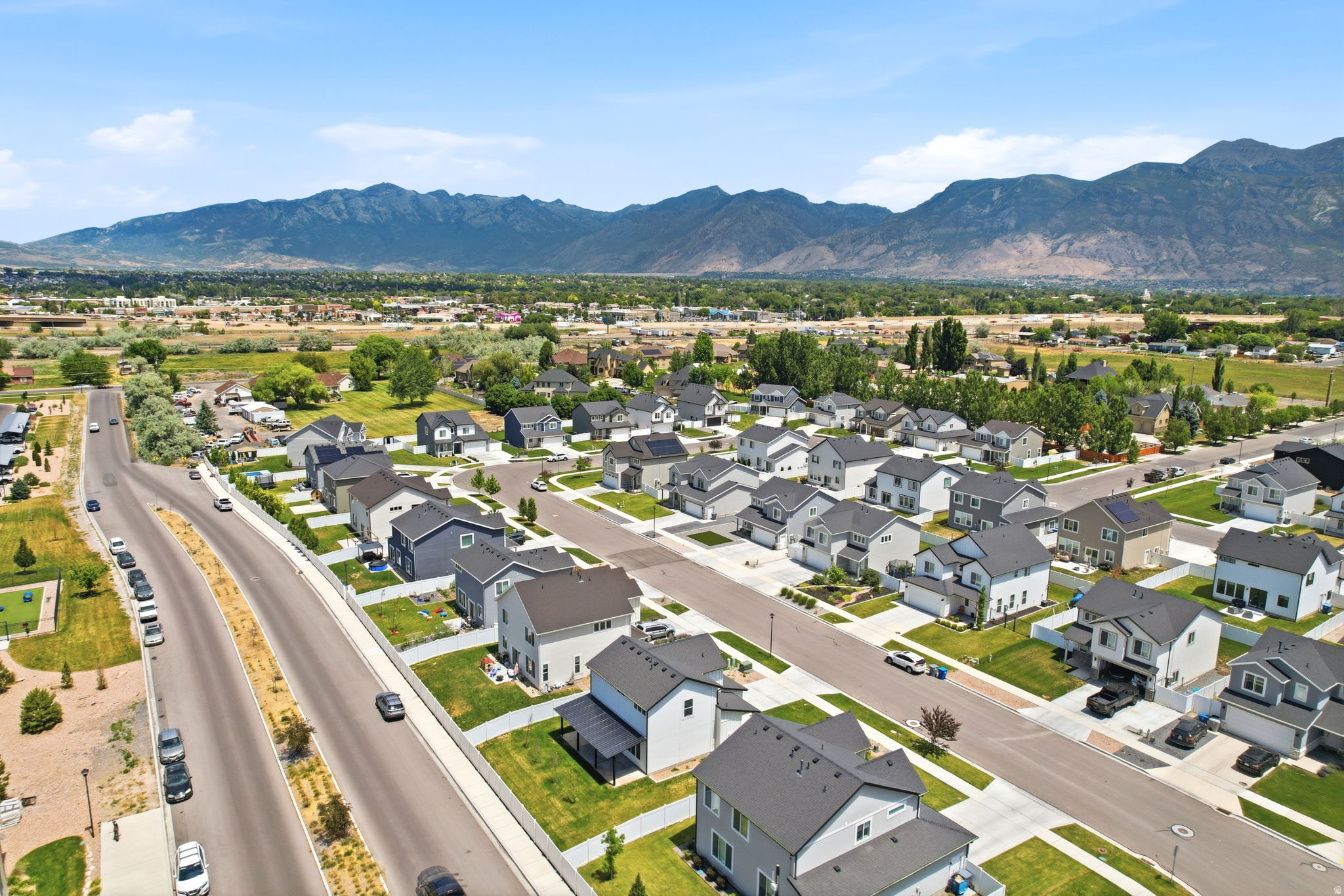Aerial perspective showcasing a residential development with mountain backdrops
