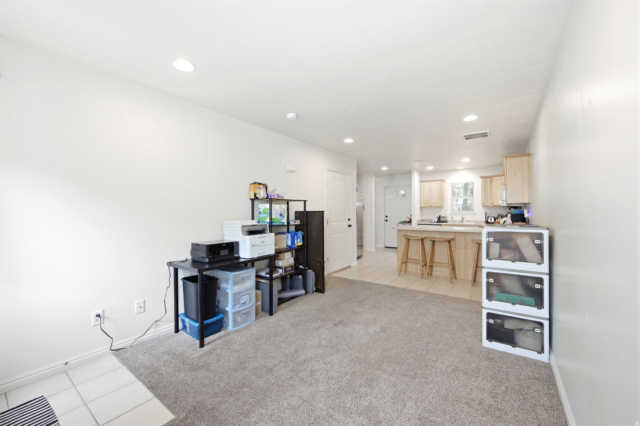 Open-concept living area featuring a carpeted space and recessed lighting