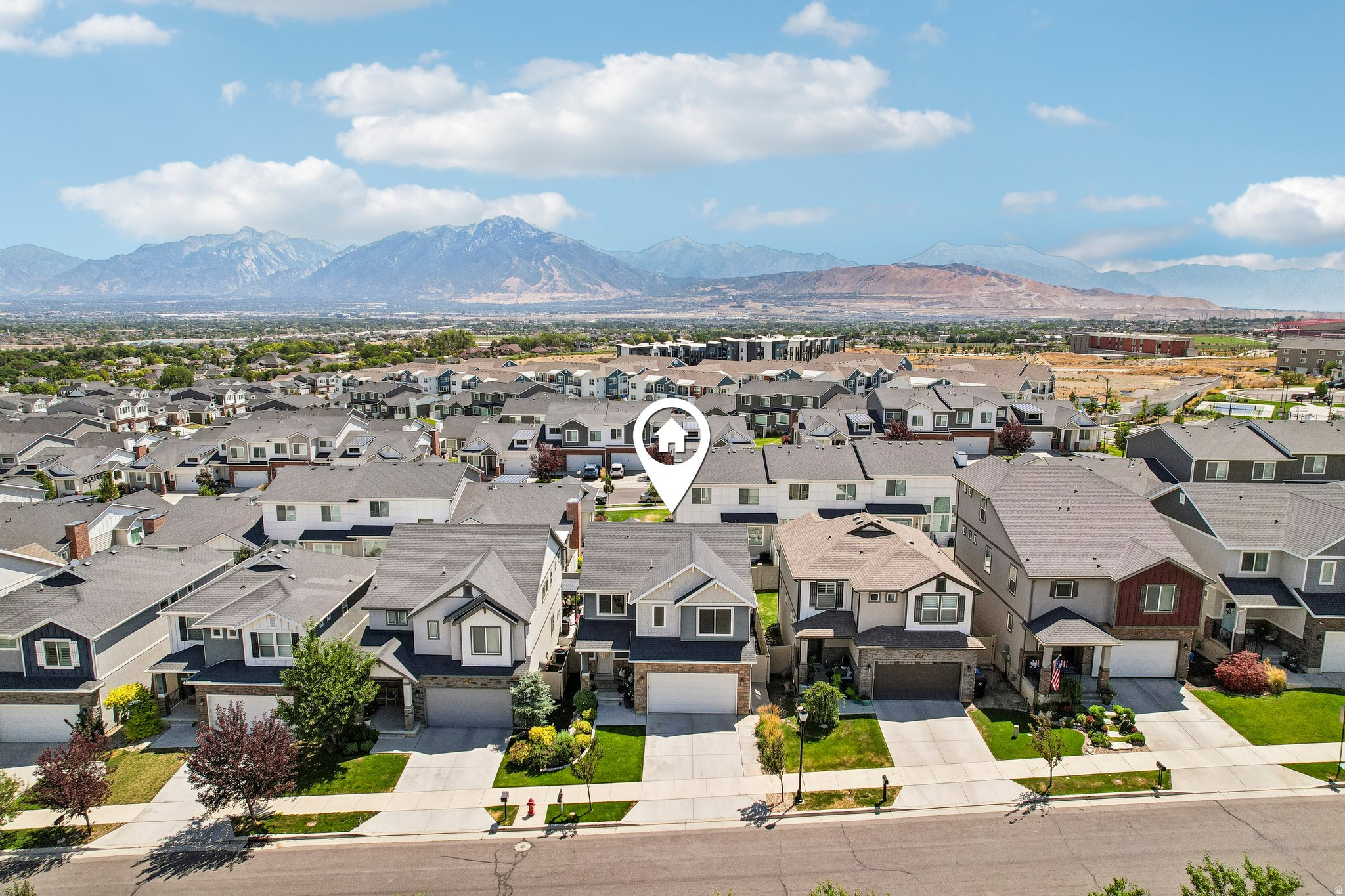 Aerial perspective showcasing a residential community with a mountain backdrop