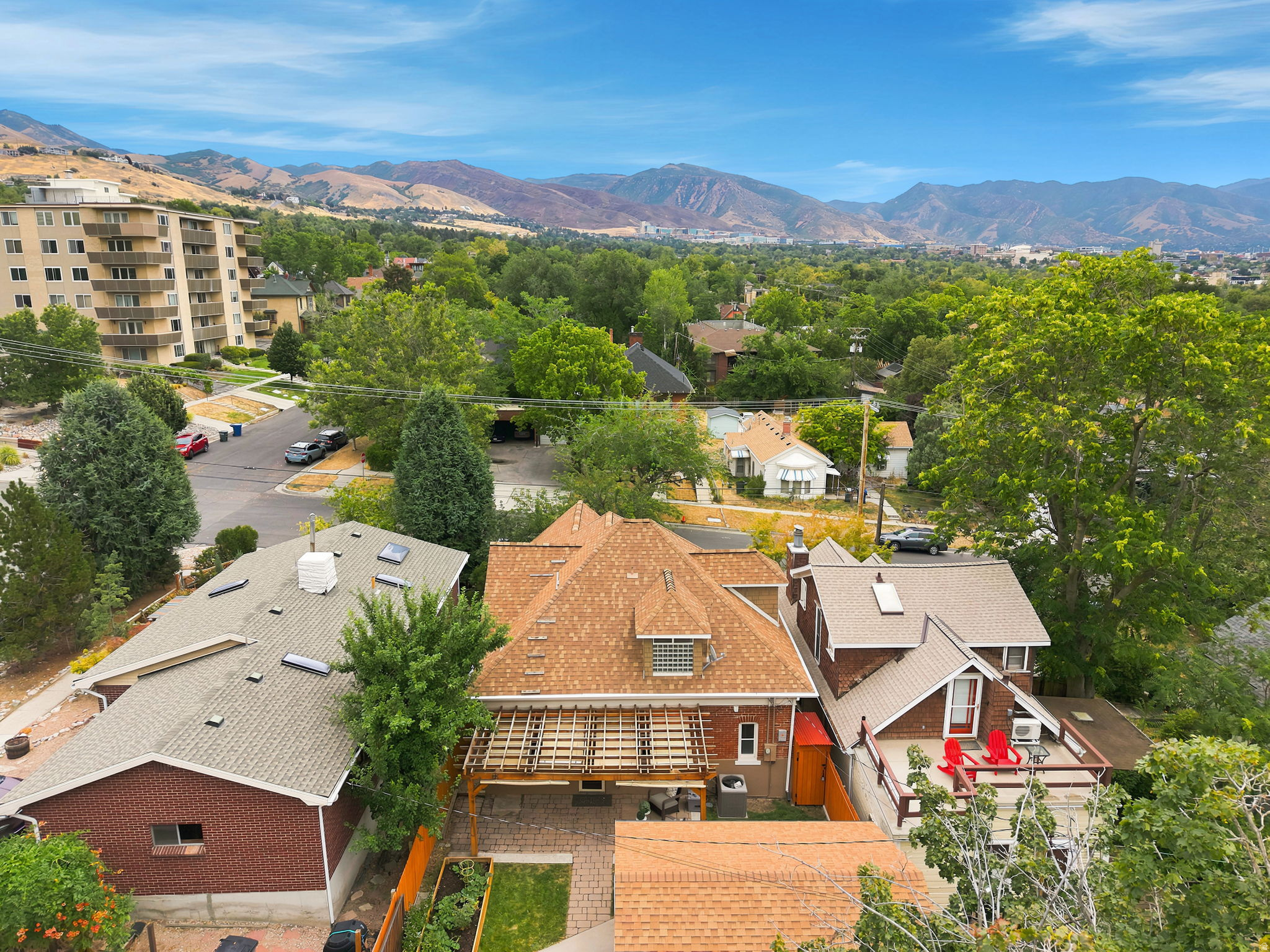 Aerial perspective showcasing a residential area with a prominent mountain backdrop