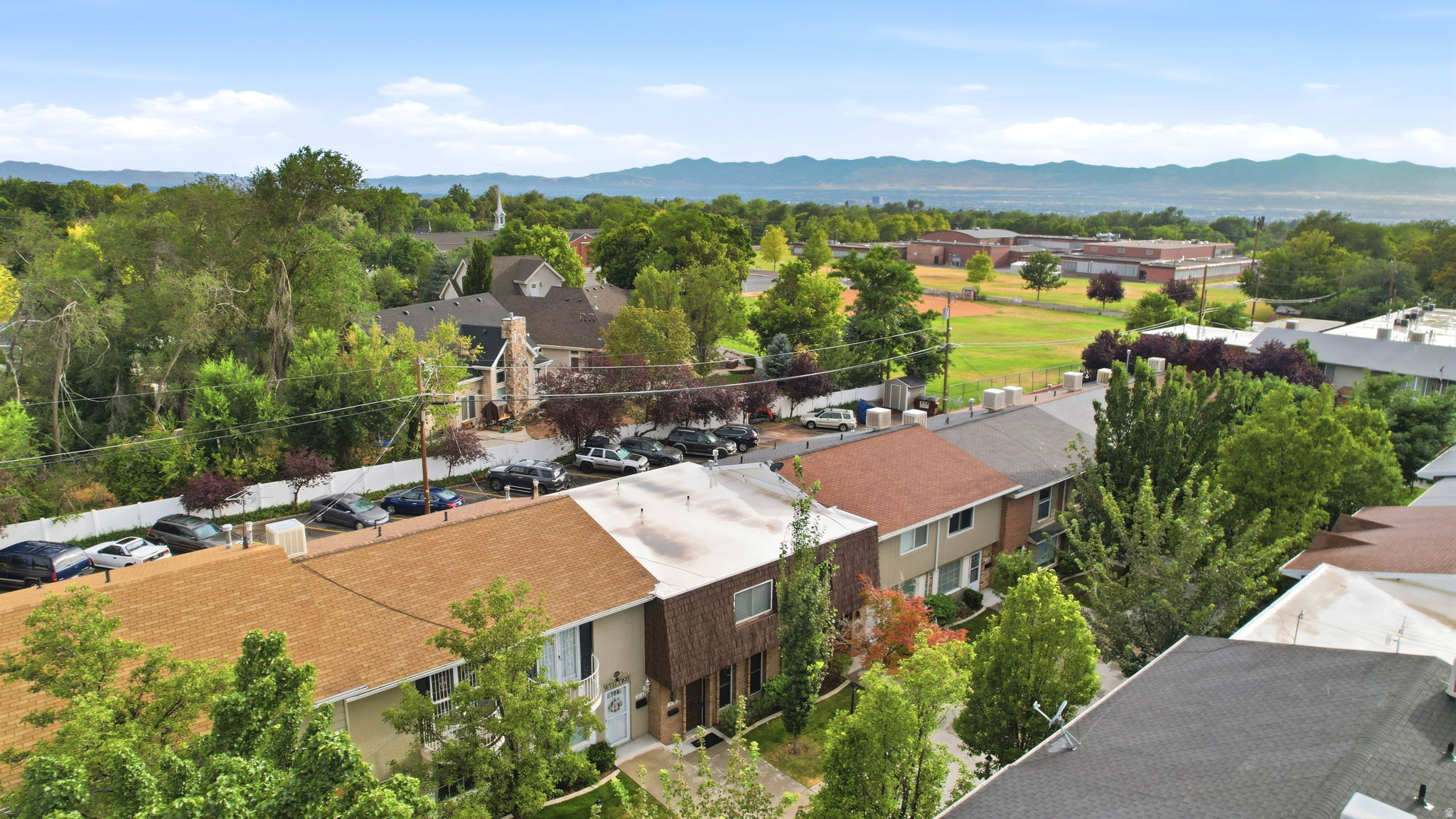 Aerial perspective showcasing residential properties with varying rooflines and exterior finishes