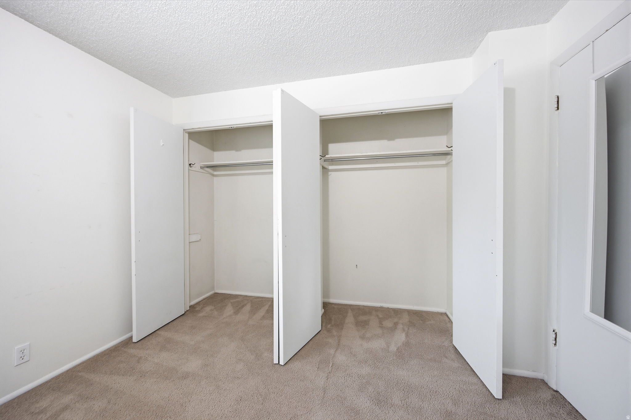 Bedroom featuring neutral carpet flooring and white painted walls