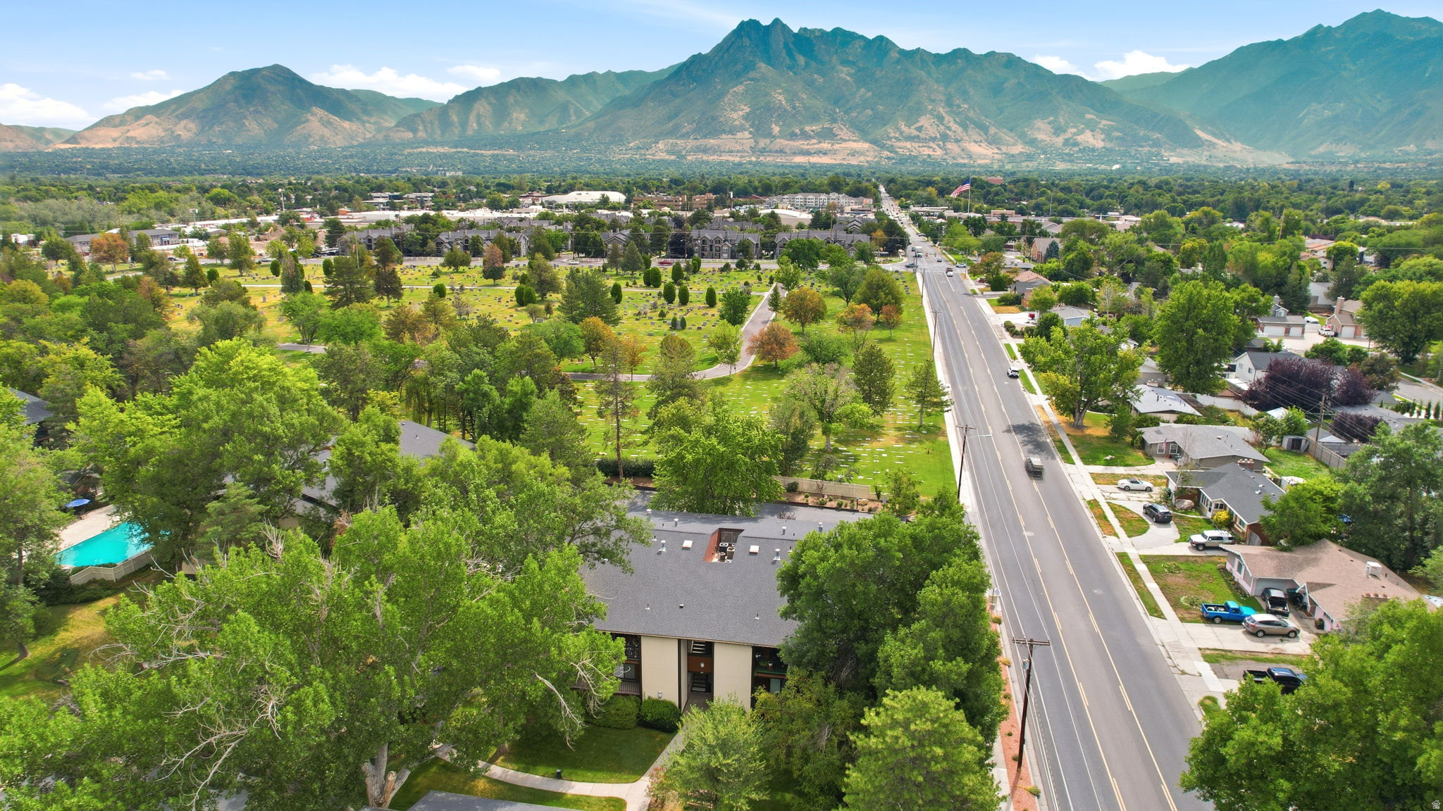 Expansive aerial perspective showcasing a residential area with a prominent multi-lane road