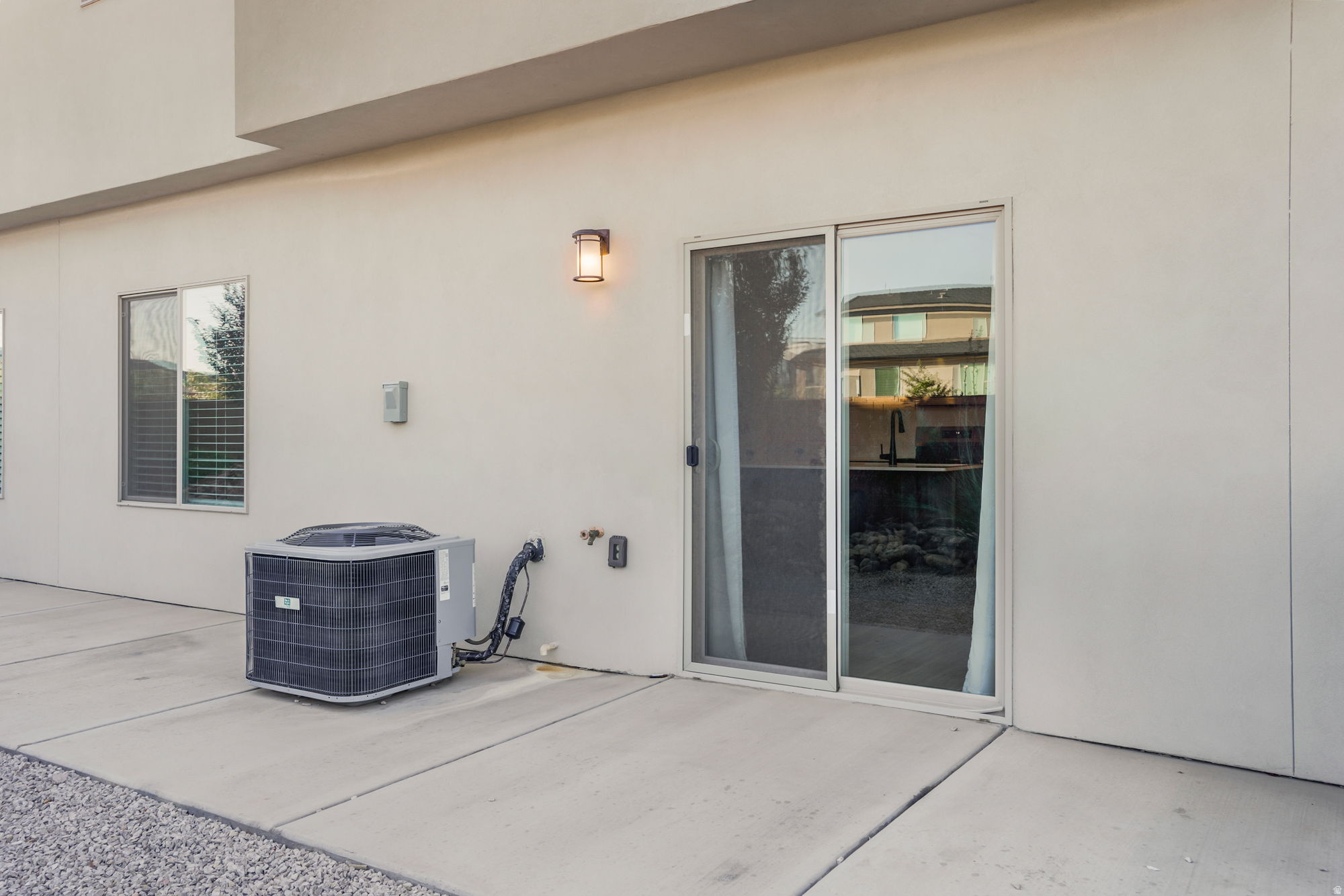 Modern patio featuring smooth concrete decking with clean sight lines to the home's glass sliding doors