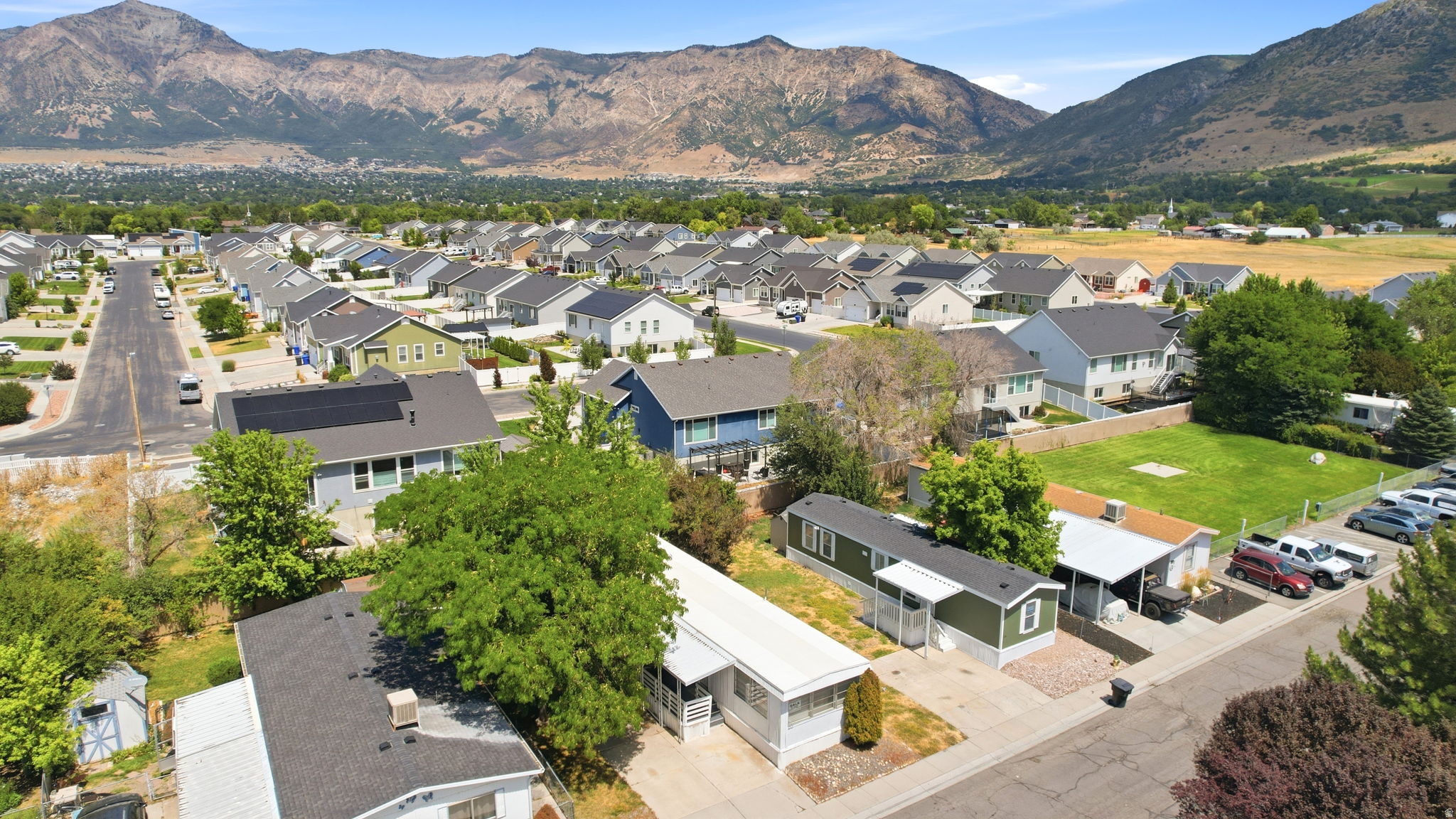 Expansive neighborhood setting featuring a variety of residential structures with mountain backdrops