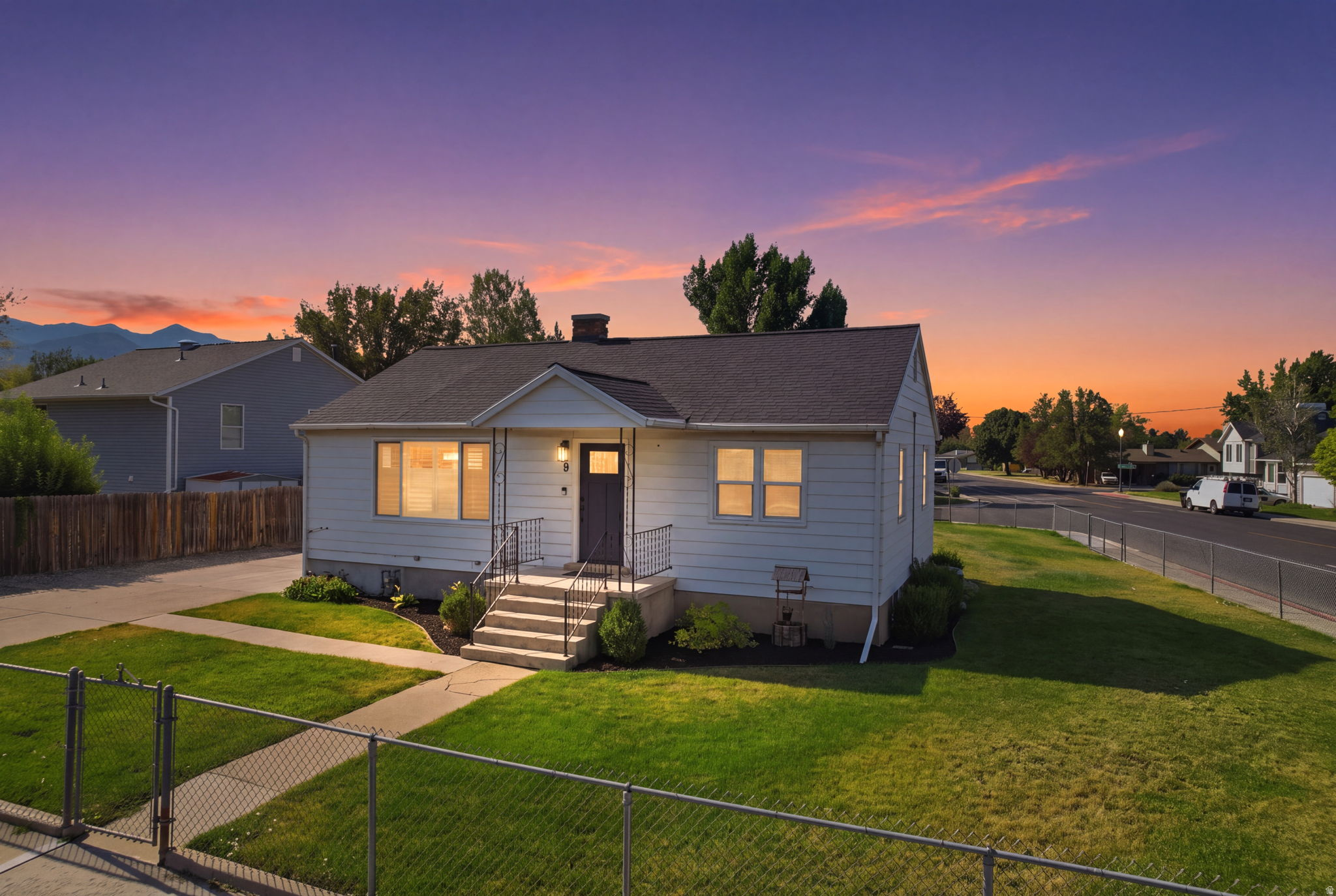 Traditional single-story home featuring light-colored siding and a dark shingle roof