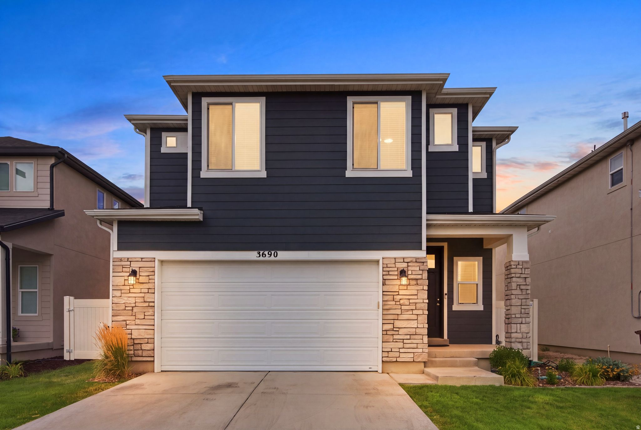 Contemporary exterior featuring deep blue siding and stone veneer accents