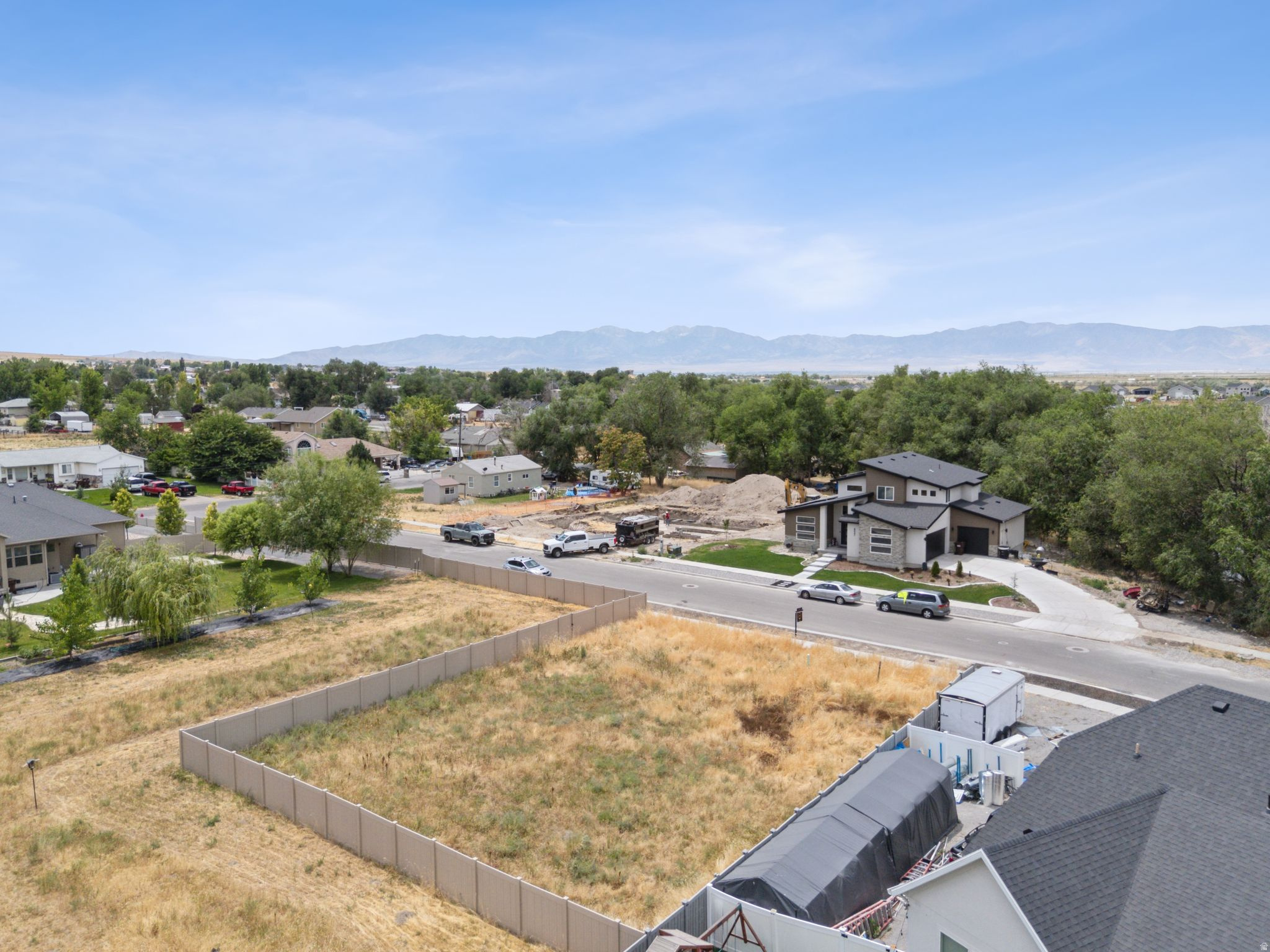 Expansive fenced lot with surrounding mountain landscape