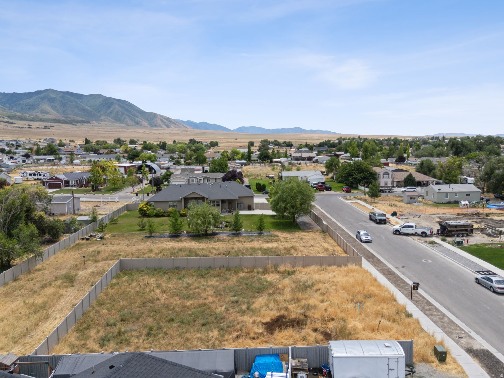 Expansive undeveloped lot with existing perimeter fencing and street frontage