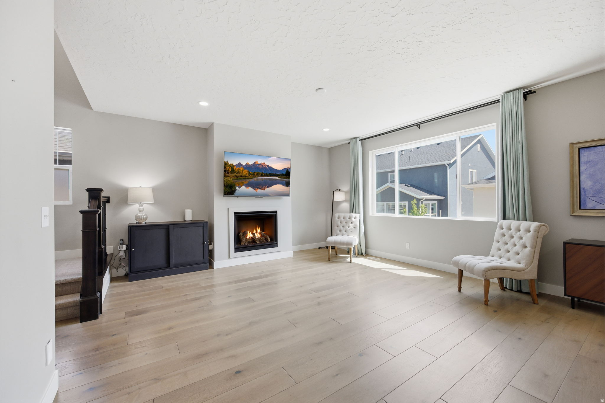 Open living area featuring light wood-finish flooring