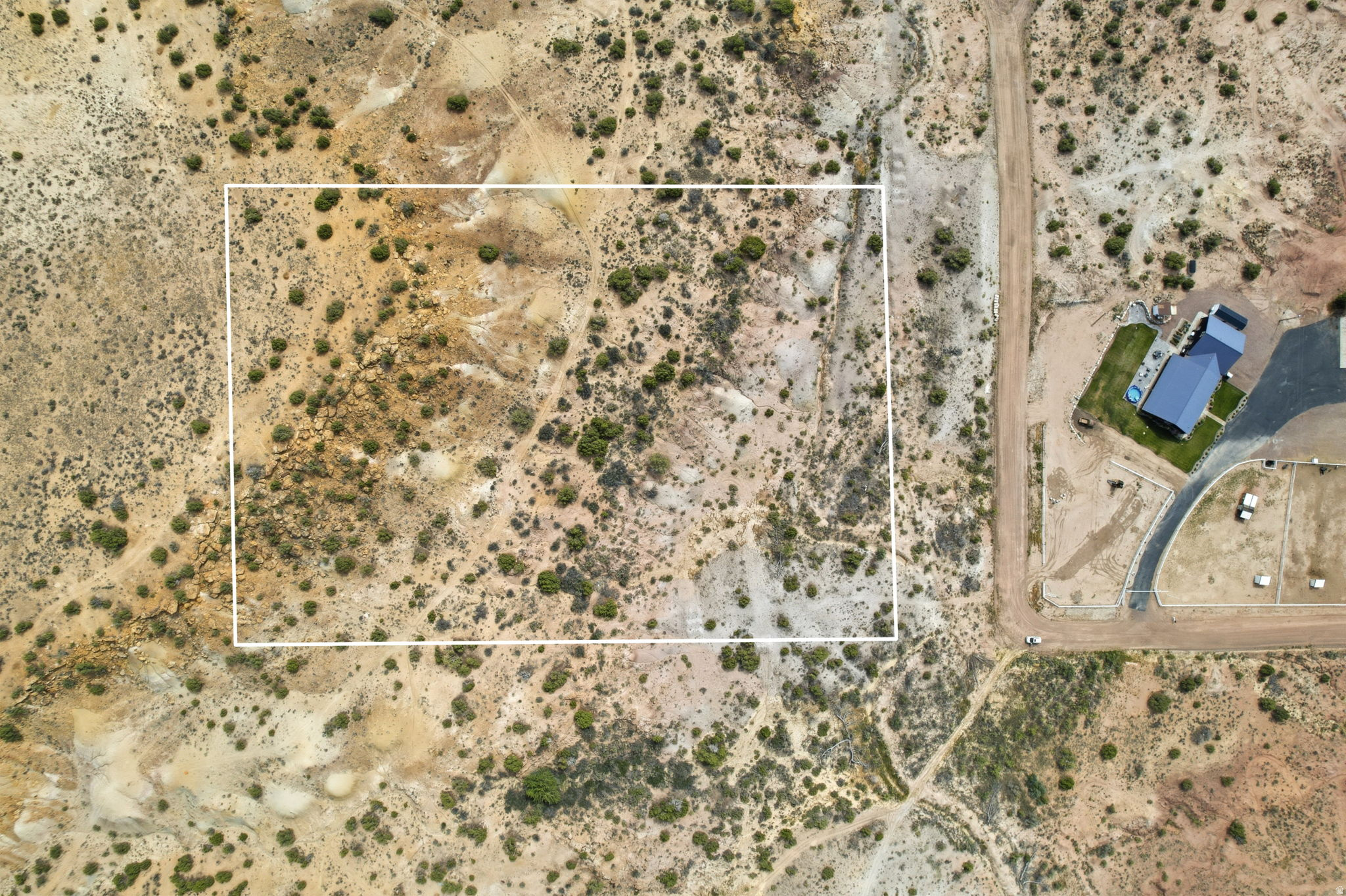 Expansive undeveloped land featuring natural terrain and sparse vegetation