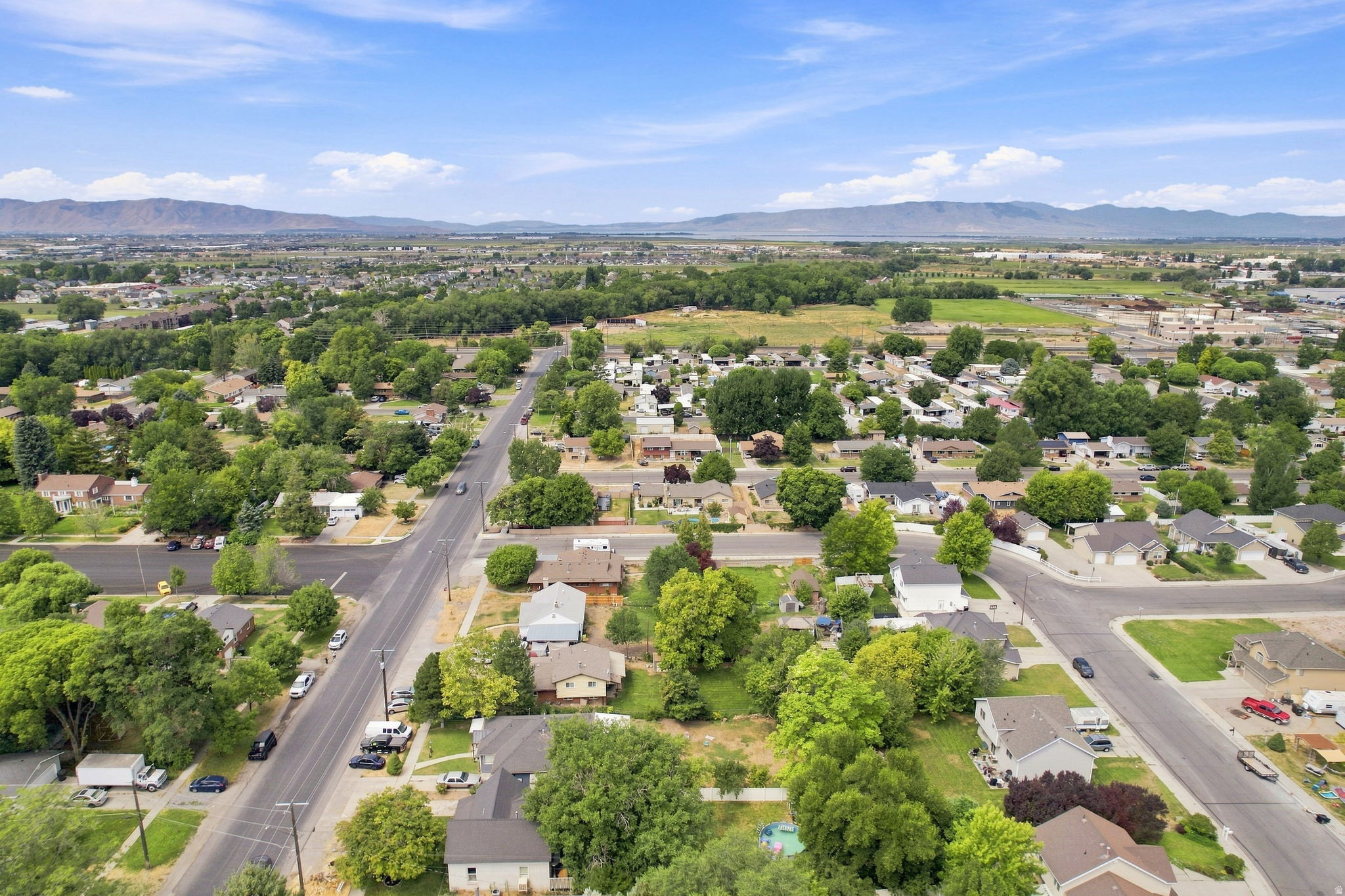 Aerial perspective of a residential area with established trees and paved roads