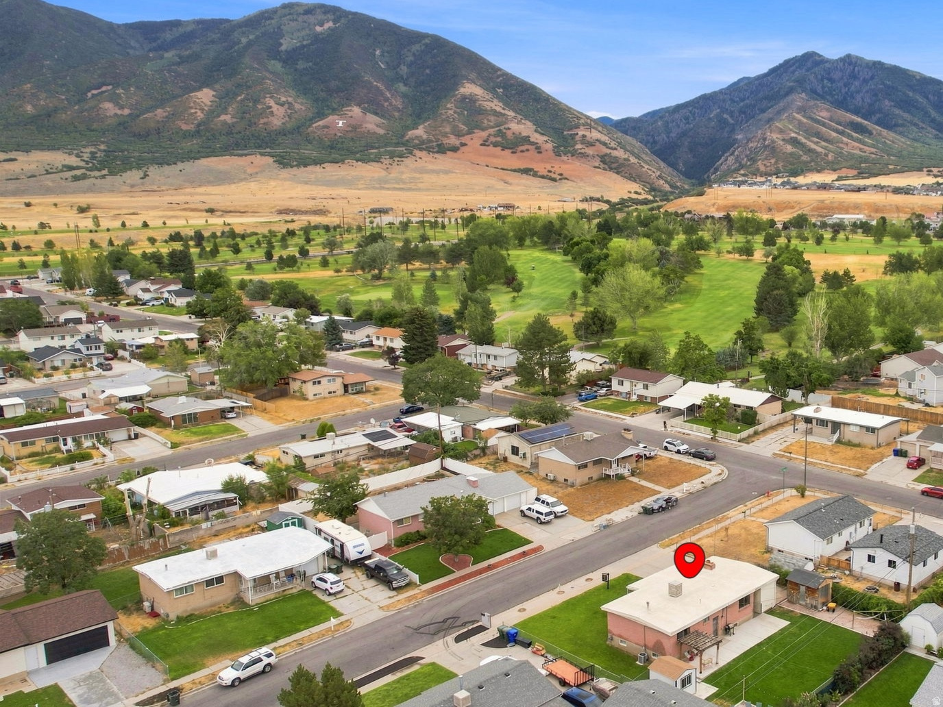 Residential neighborhood setting with mountain backdrop and green spaces
