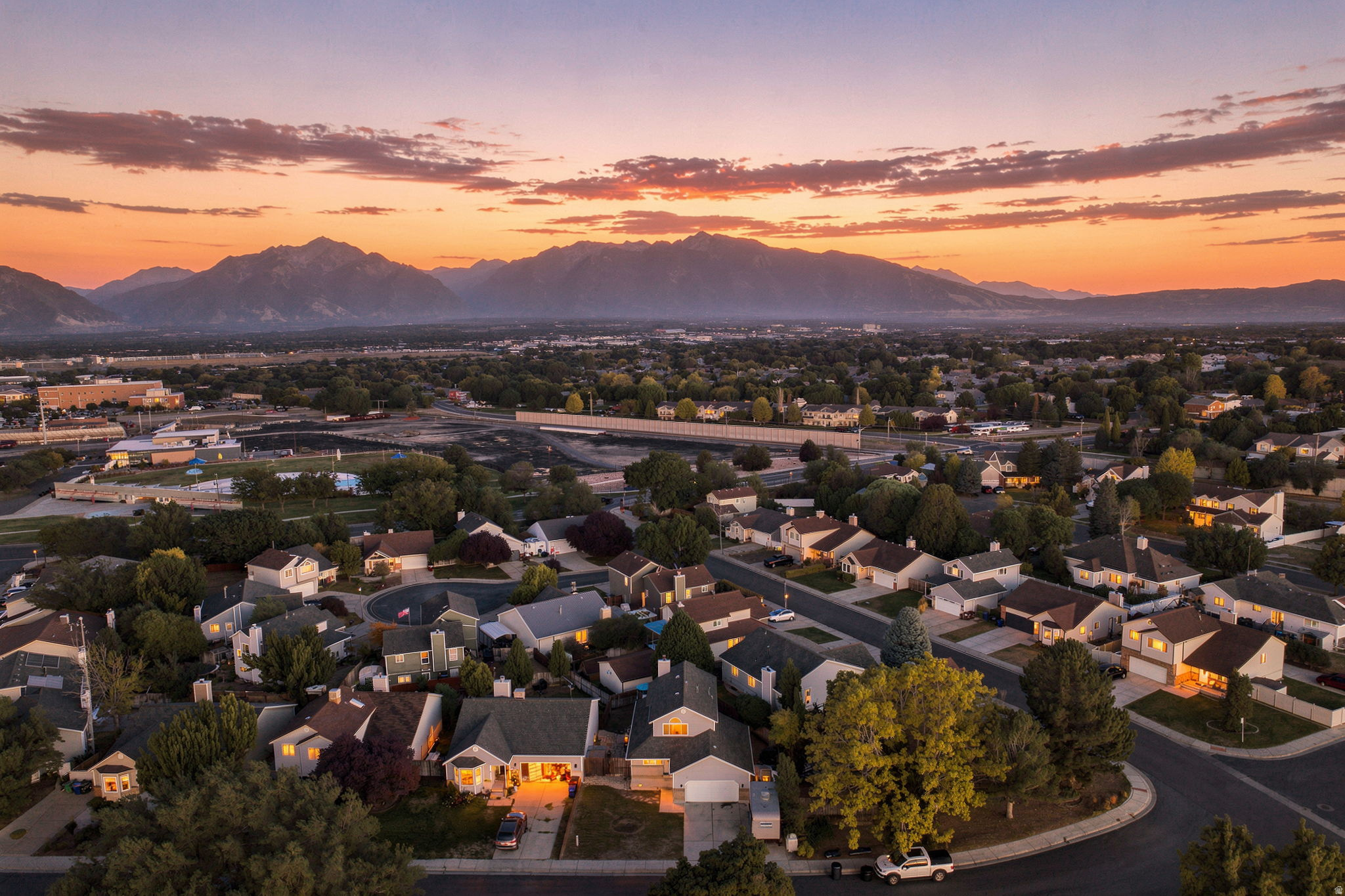 Residential neighborhood with tree-lined streets and mountain scenery